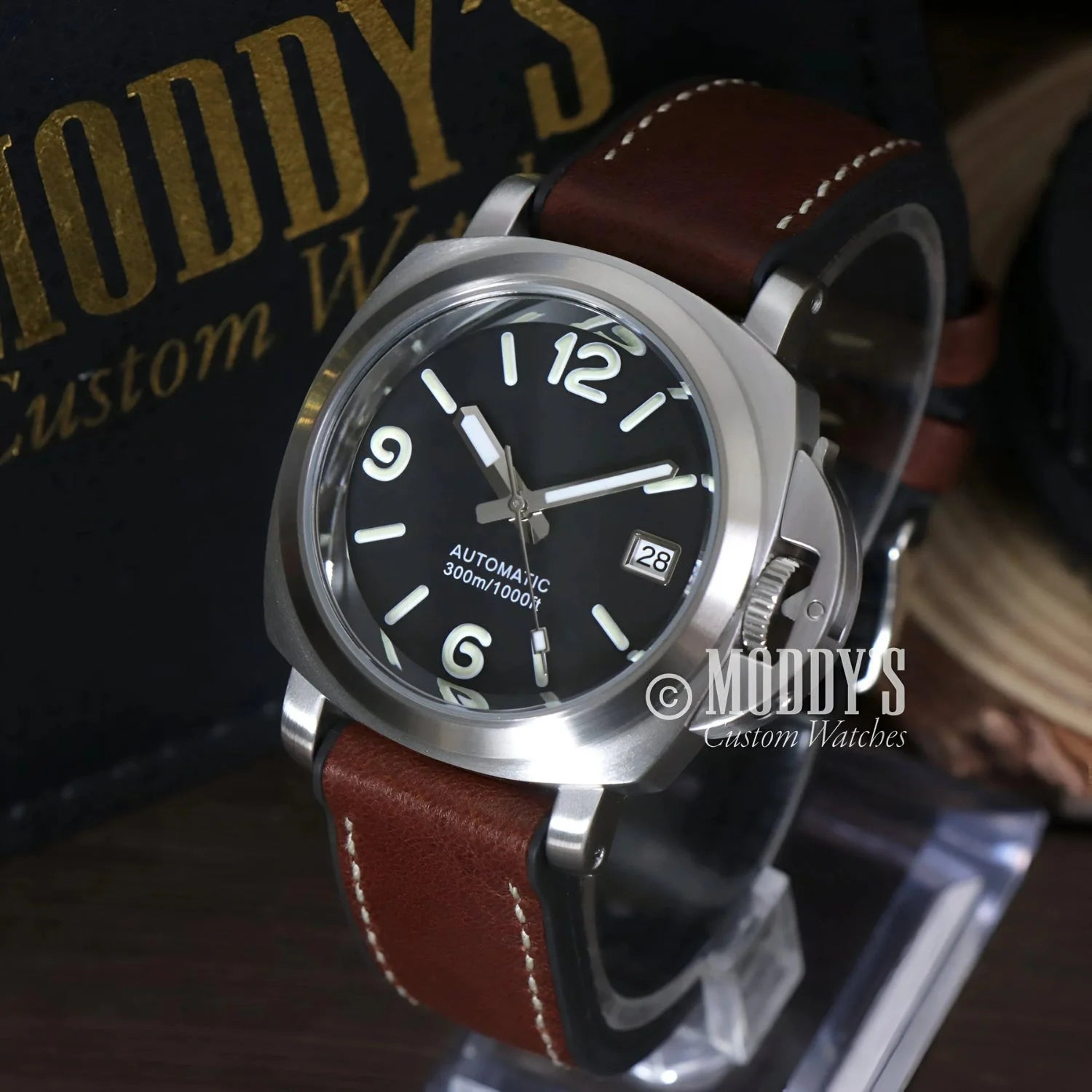 Silver wristwatch with brown leather band featuring Seiko NH35 automatic movement