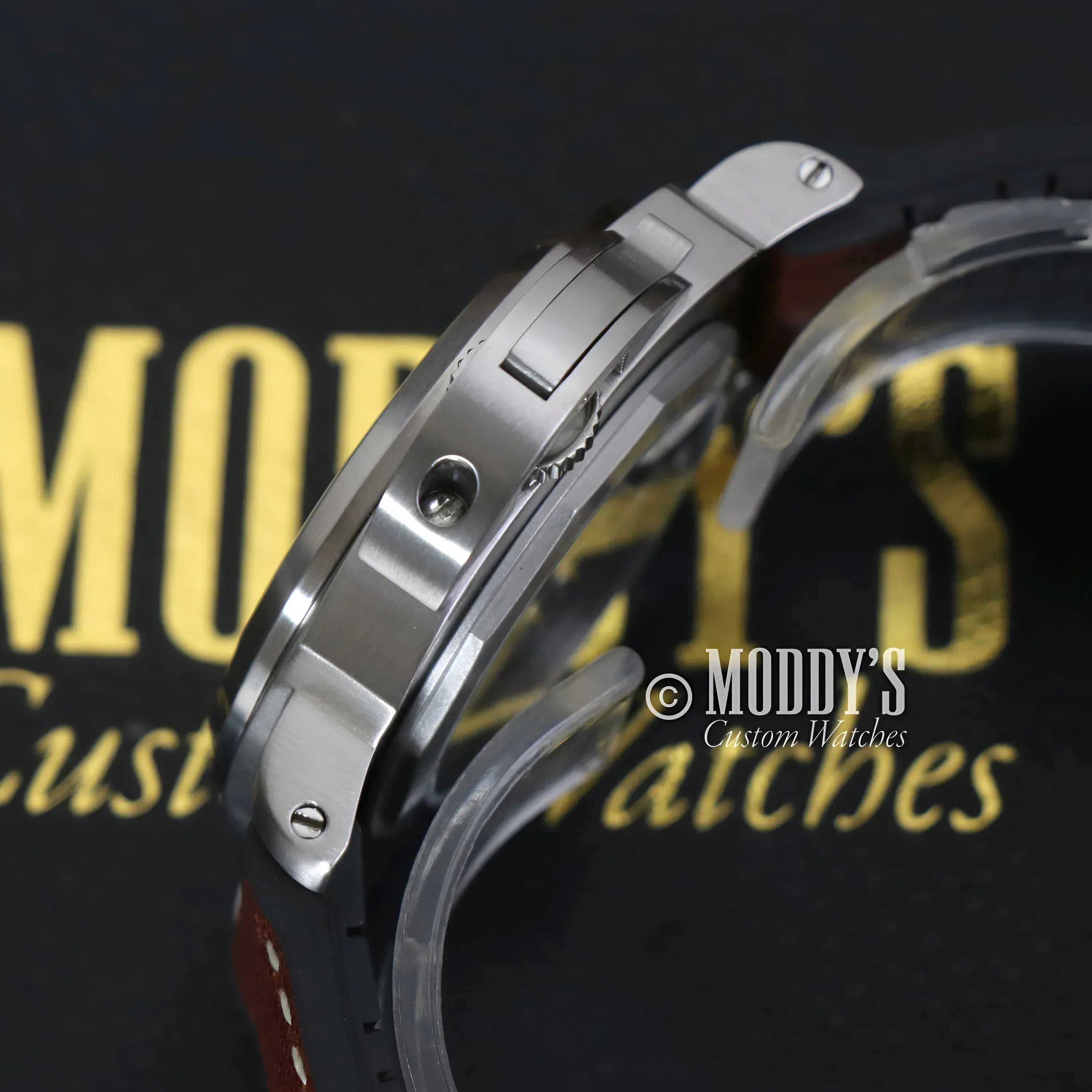 Silver wristwatch with brown leather band featuring Seiko NH35 automatic movement