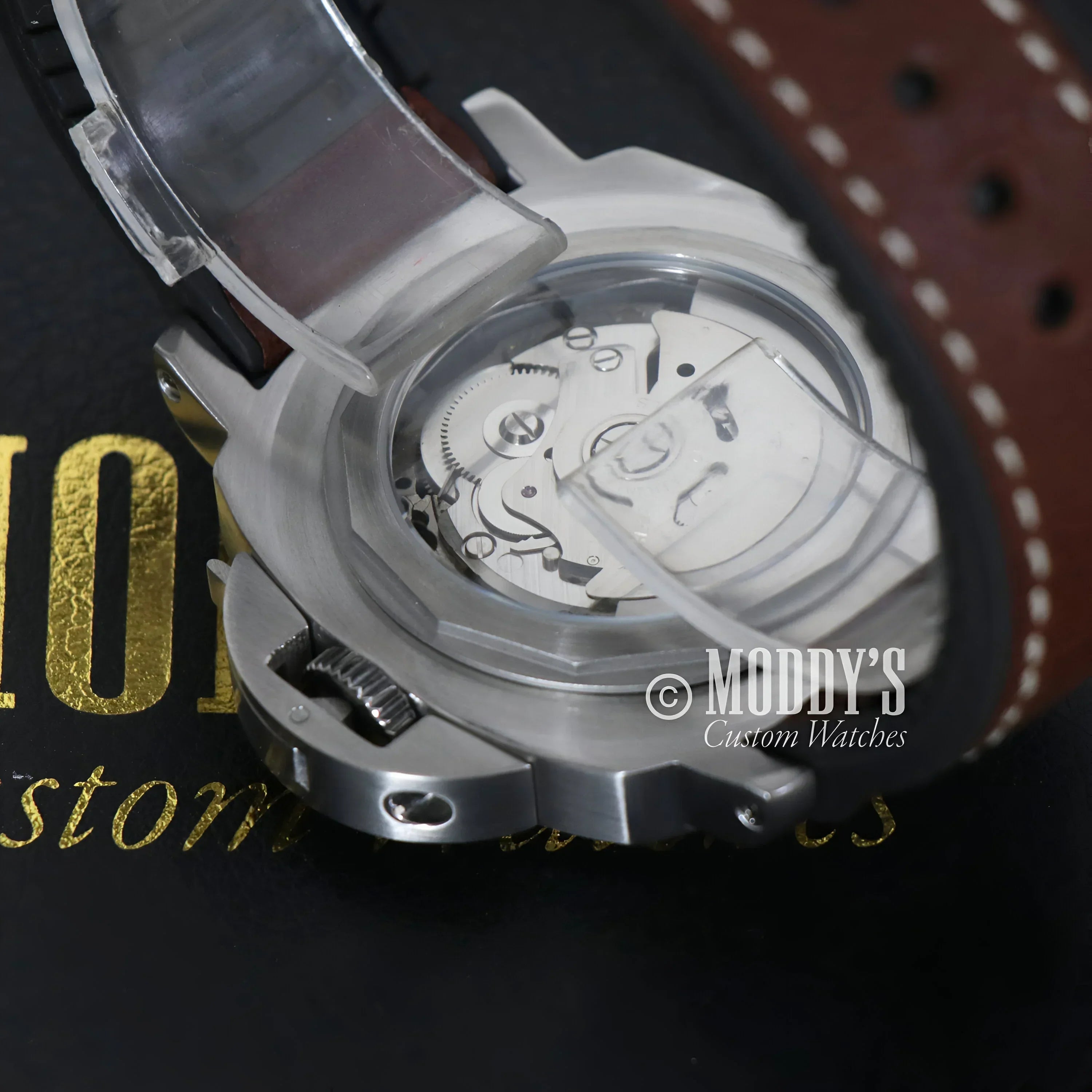 Silver wristwatch with exposed gears featuring Seiko NH35 automatic movement in iconic Luminor design