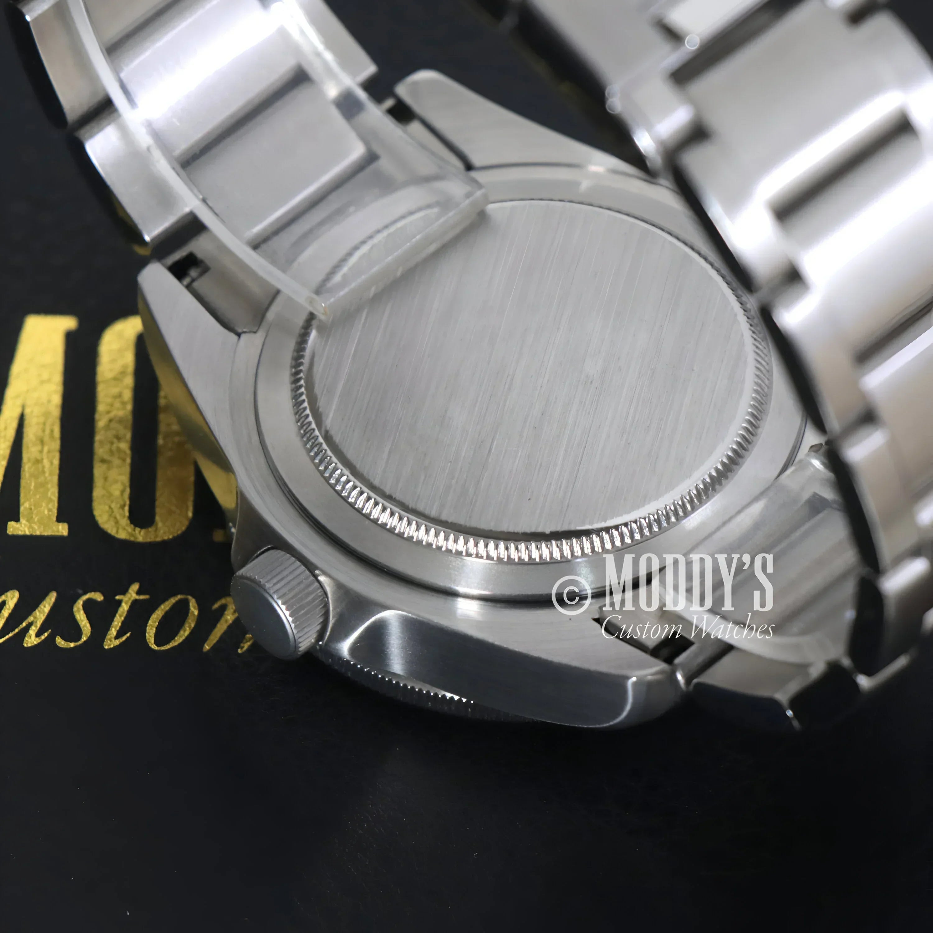 Silver wristwatch with metal band from Tudeiko Pelagos Black featuring Seiko NH35 automatic