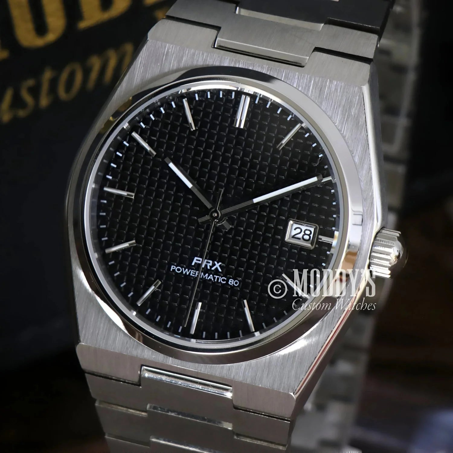 Silver Tissot PRX Powermatic 80 wristwatch in PRXeiko black, featuring NH35 automatic movement