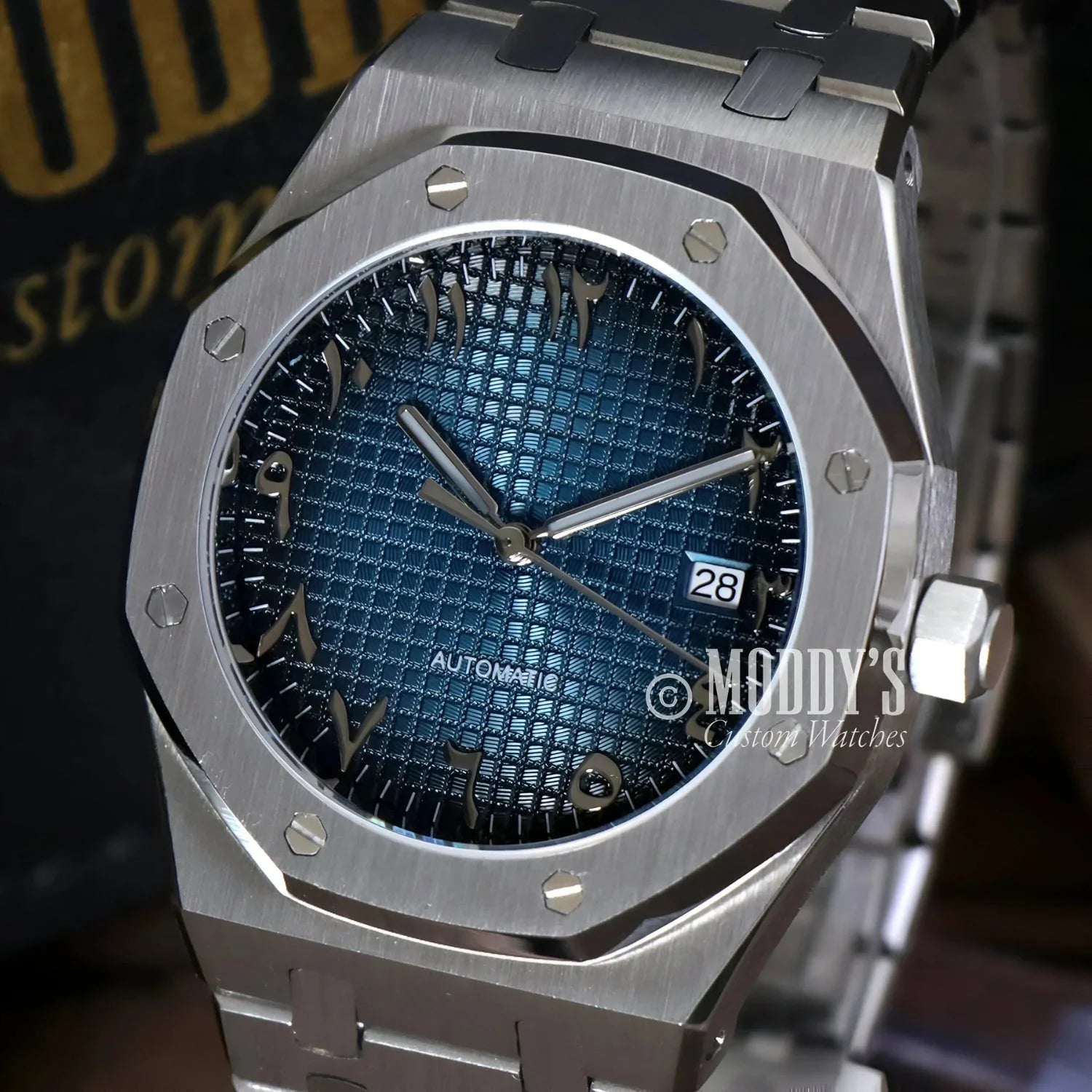 Silver wristwatch Royal Seikoak with blue patterned face and Arabic Blue design