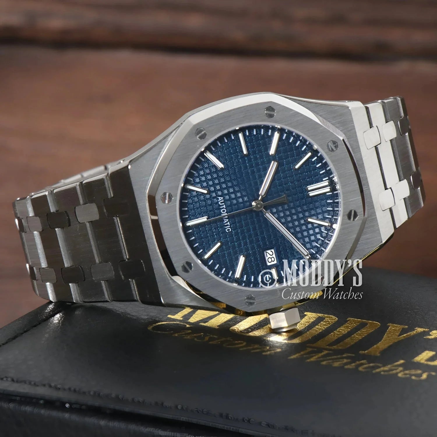 Silver wristwatch with blue face from the Seiko Mod Royal Oak collection