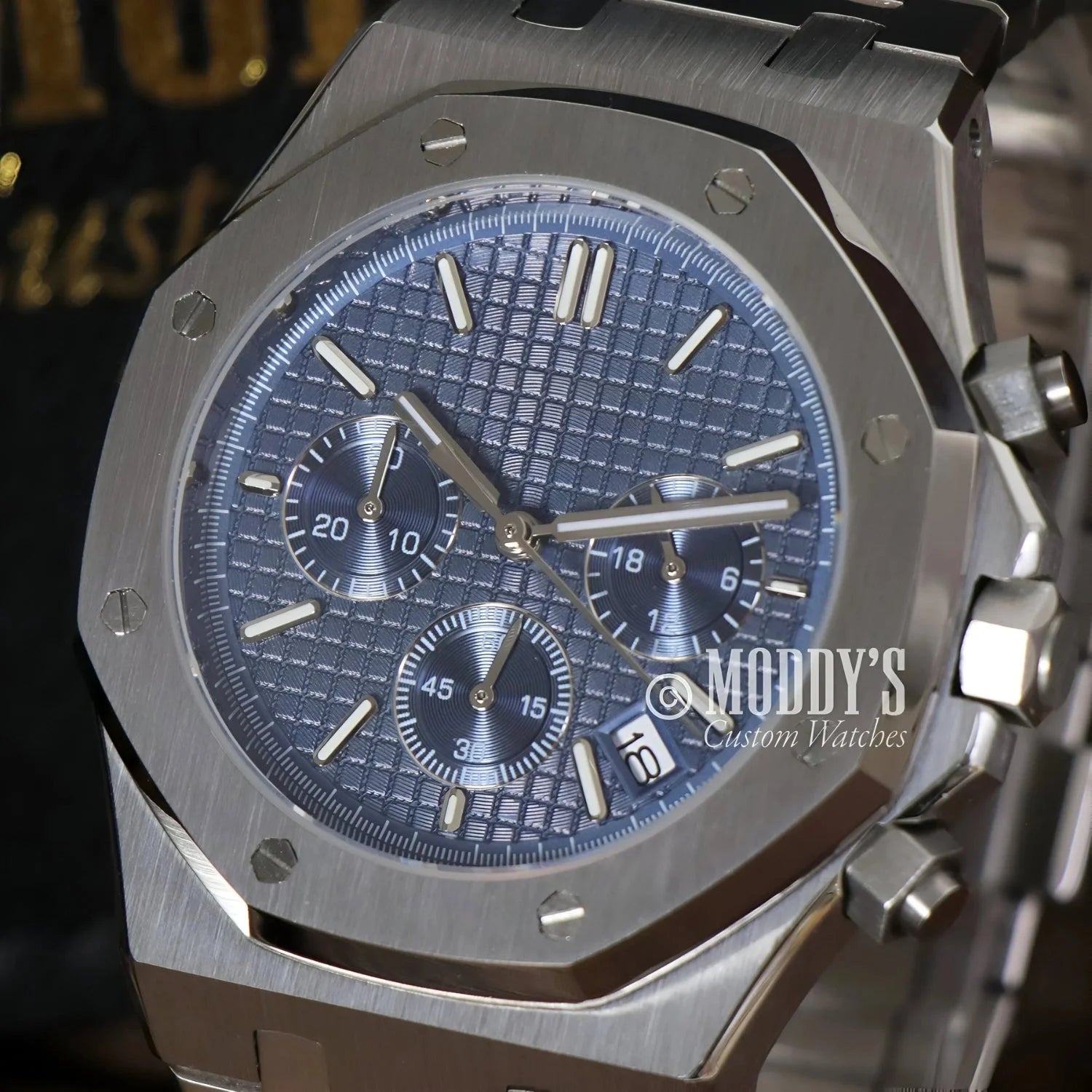 Silver chronograph wristwatch with blue patterned face, Royal Seikoak featuring VK63 hybrid movement