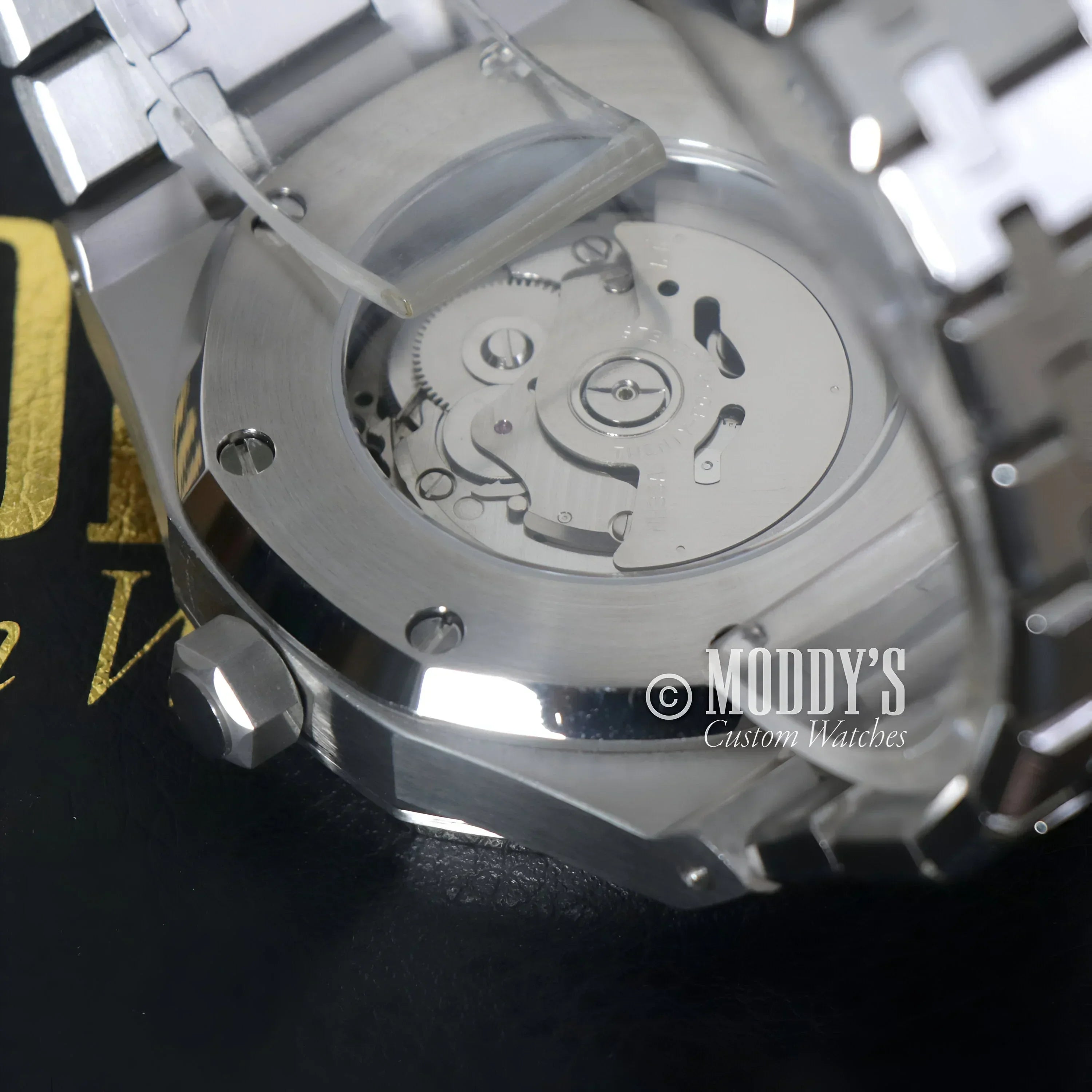 Silver wristwatch with exposed movement in Royal Seikoak Olive Green design