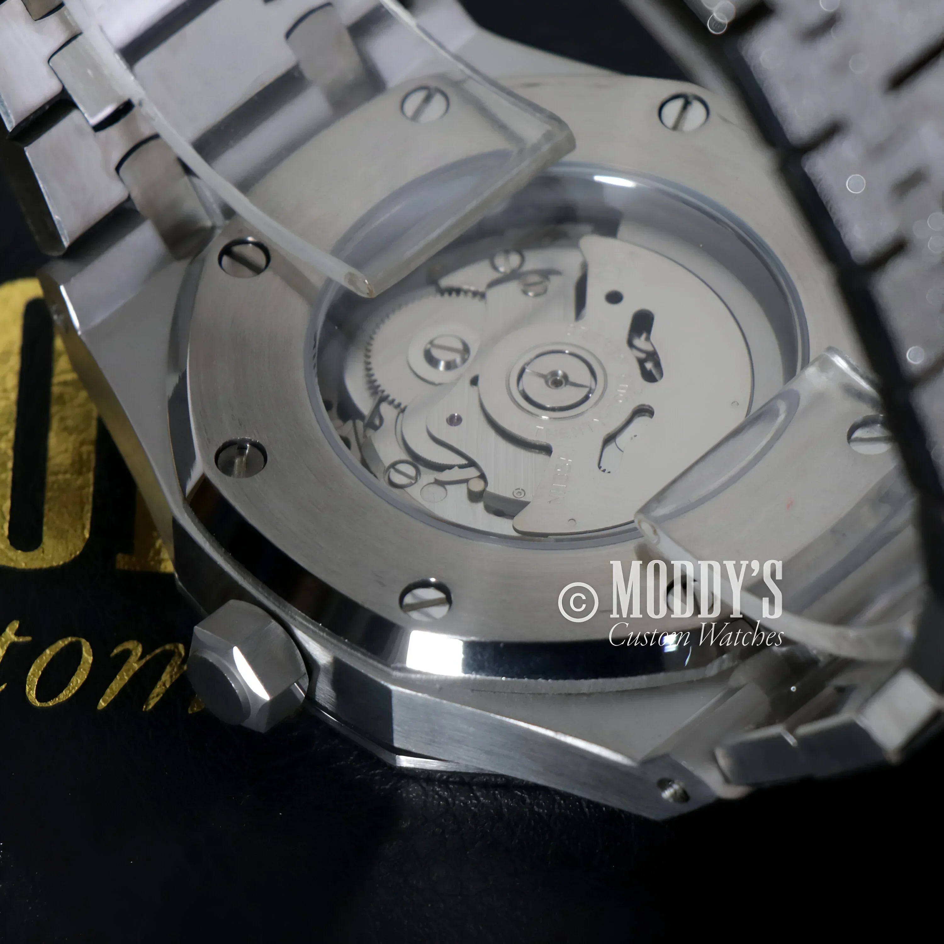 Silver wristwatch with exposed NH35 automatic movement in Royal Seikoak design