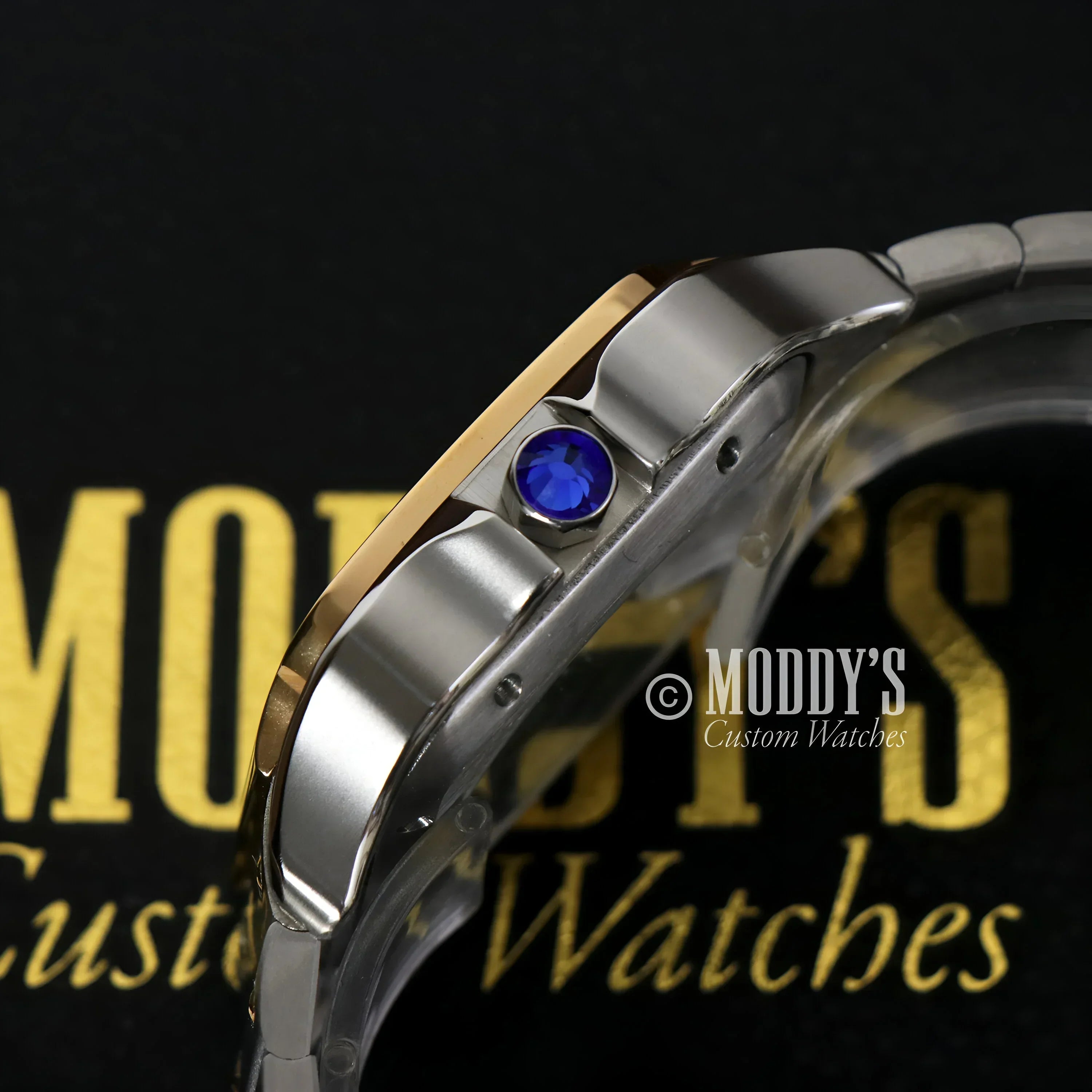Silver and gold watch with blue jewel, featuring Seiko NH35 automatic movement