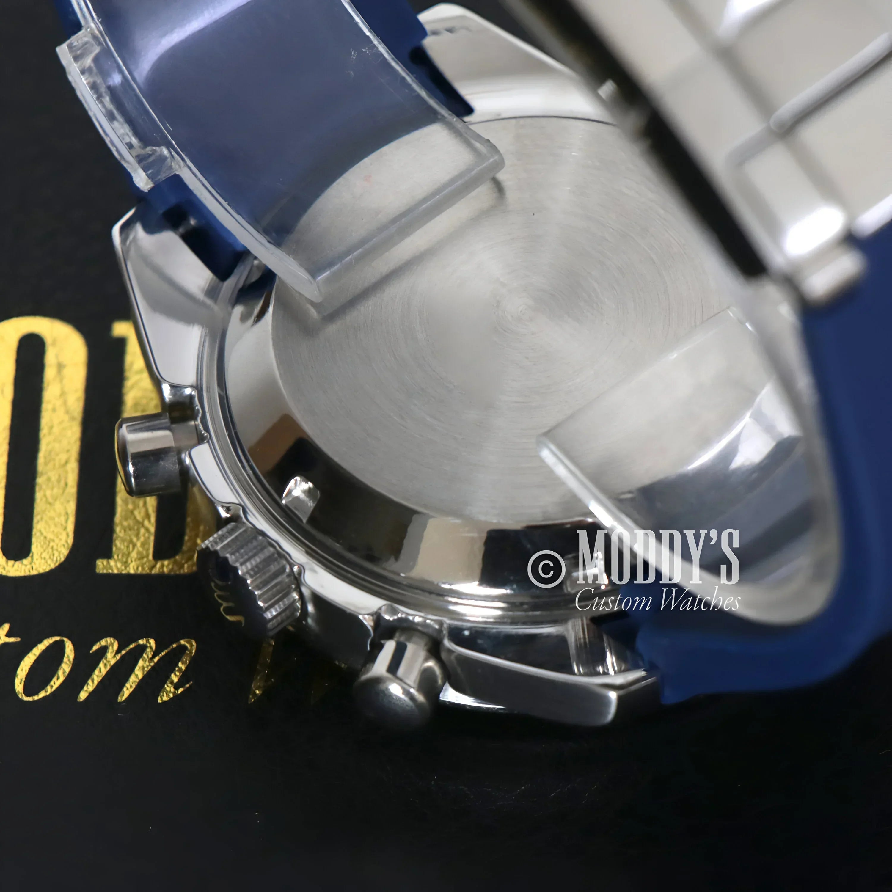 Silver wristwatch with blue band from Speedseiko Snoopy Blue collection, featuring Seiko VK63 hybrid
