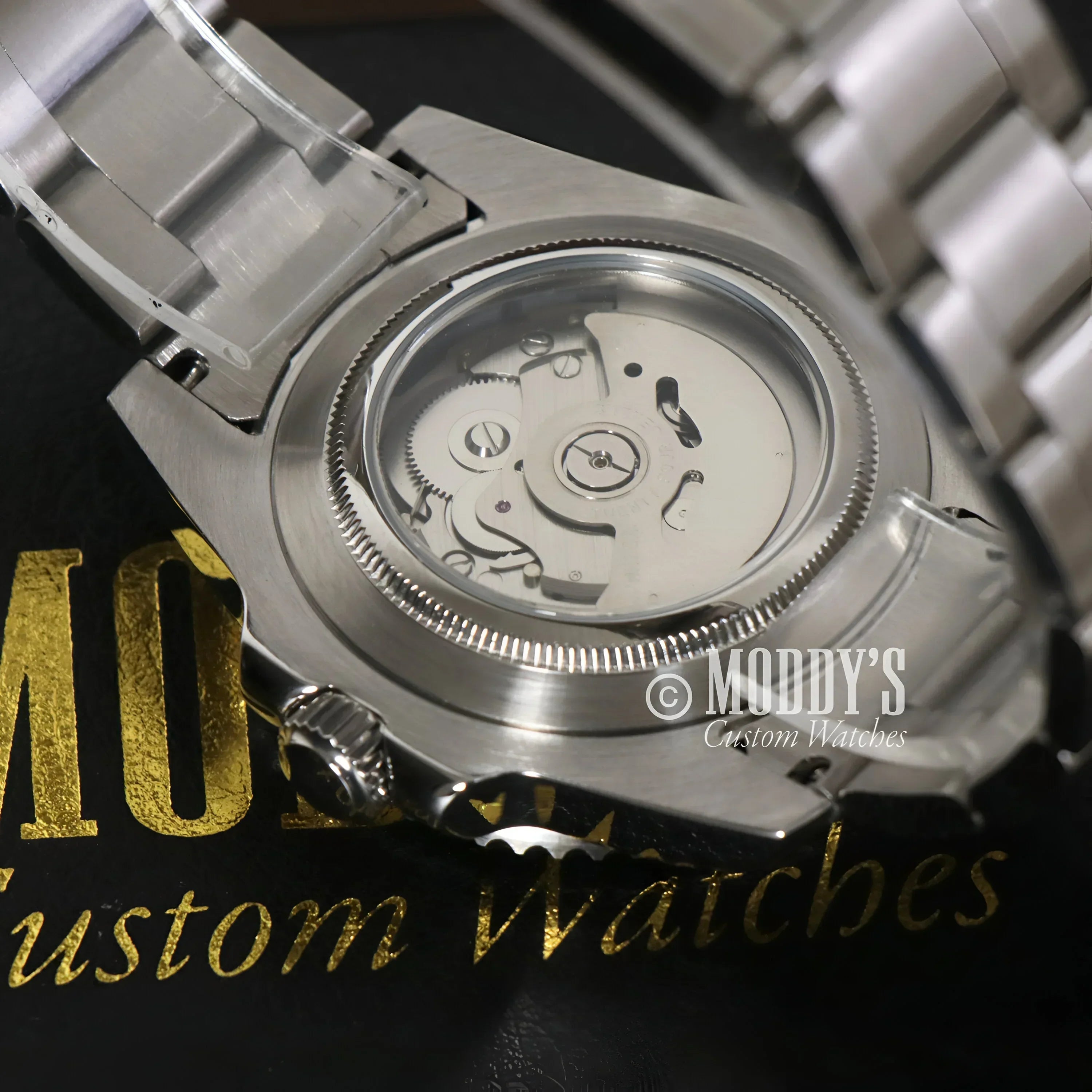 Silver Seiko mod Submariner wristwatch showcasing NH35 automatic movement details