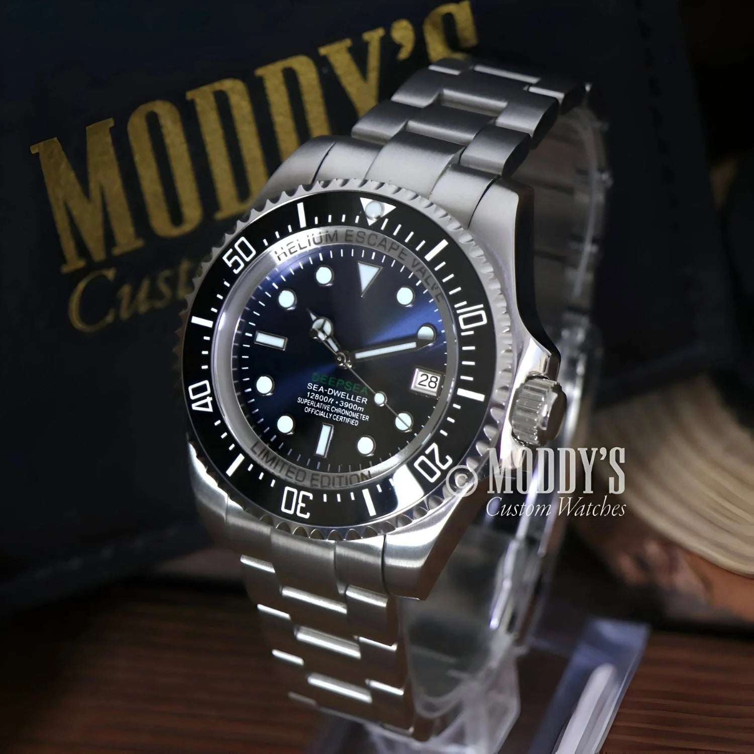 Silver wristwatch with black bezel from Seikomariner Deepsea, featuring Seiko NH35 automatic
