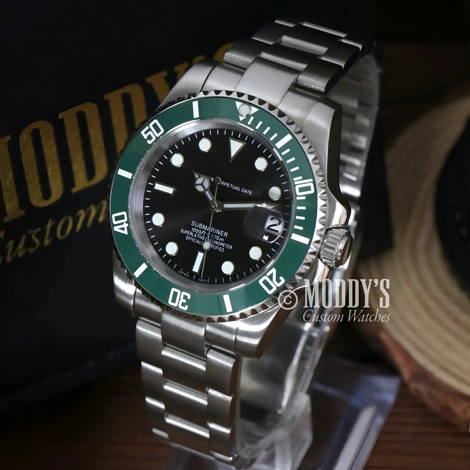 Silver Seiko Mod wristwatch with green bezel, featuring Seiko NH35 automatic movement