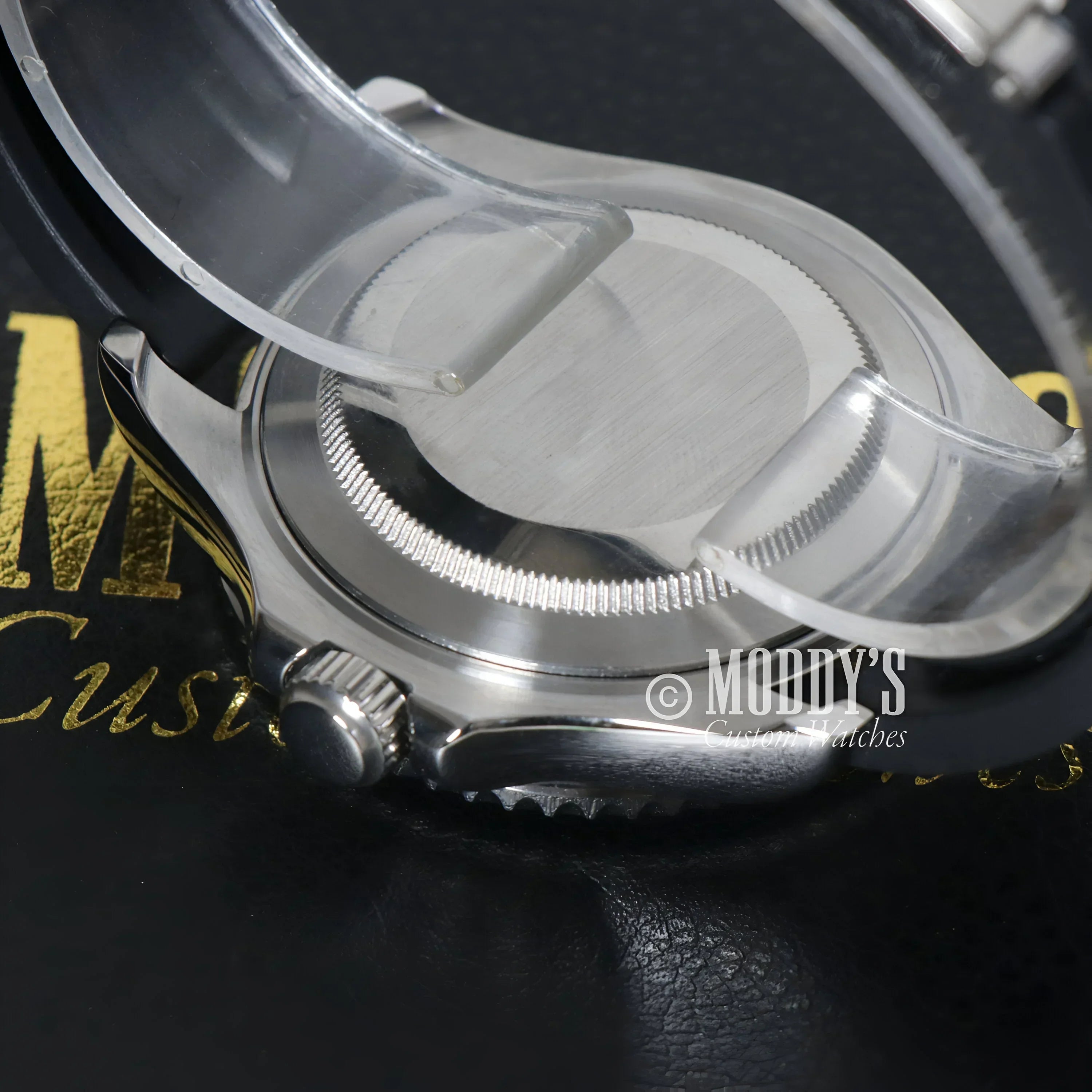 Silver wristwatch with protective plastic featuring Seiko NH35 automatic movement