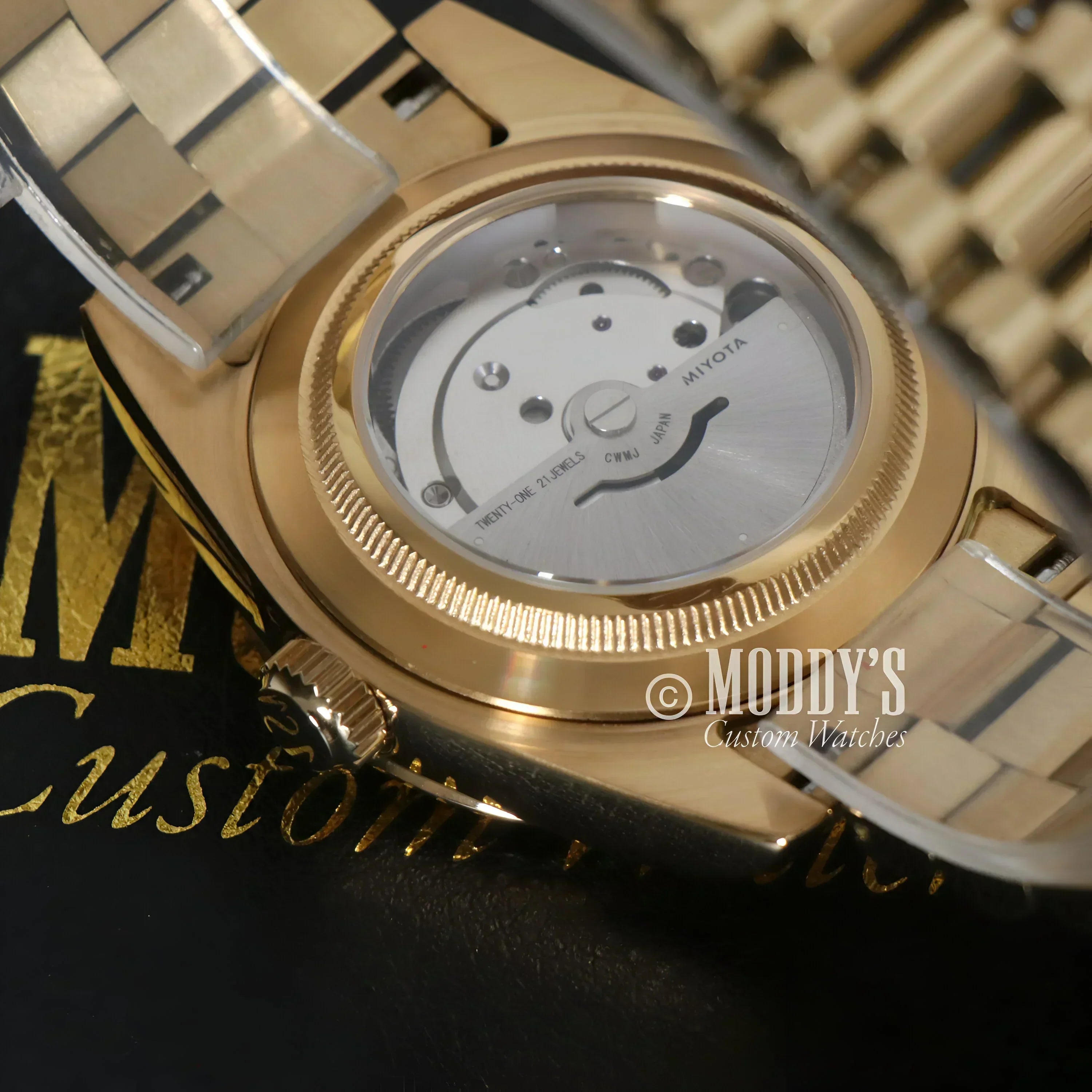 Gold-toned Seikojust Daydate Yellow Gold wristwatch showcasing visible movement design