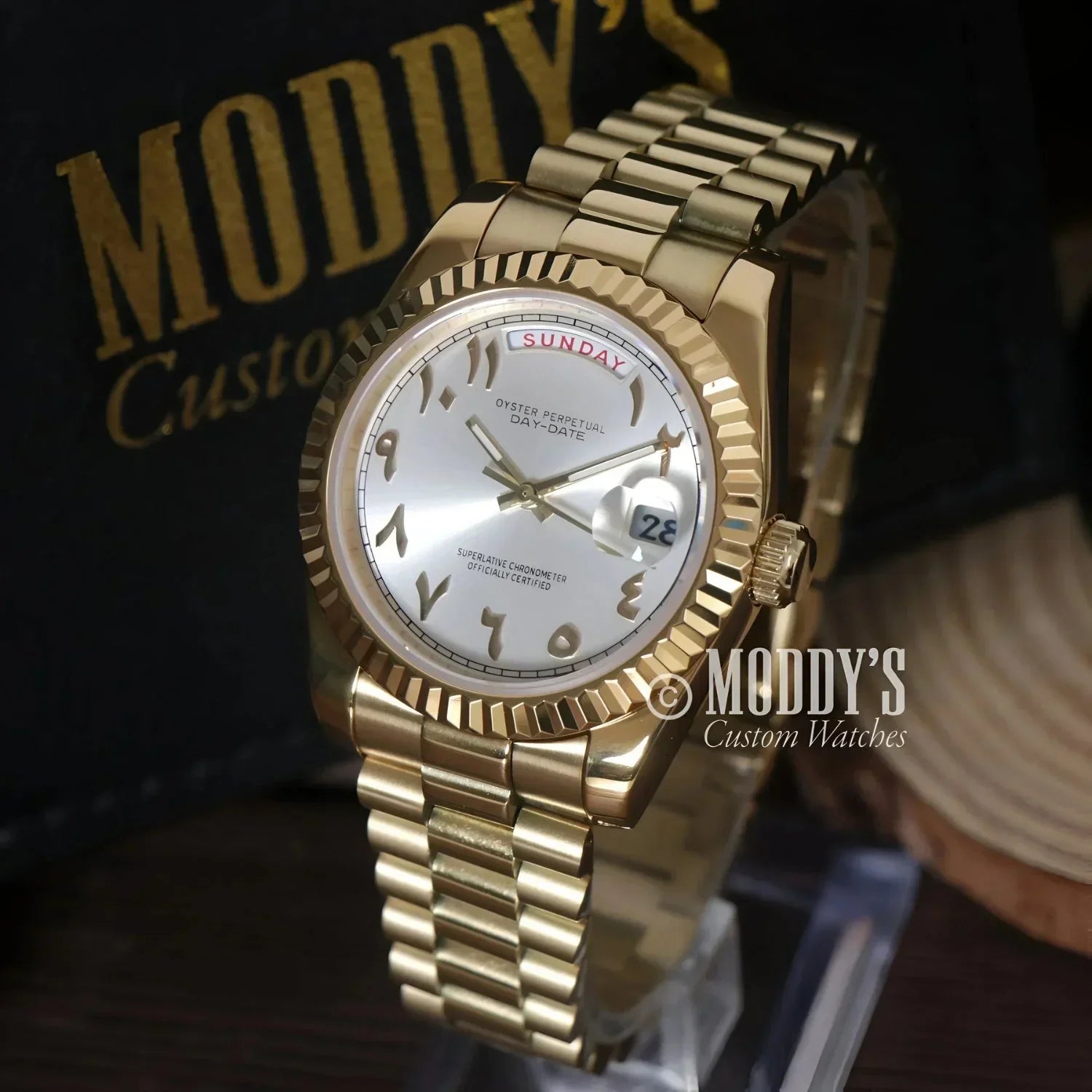 Gold Rolex Day-Date wristwatch displayed in Seikojust Daydate Yellow Gold - White Arabic