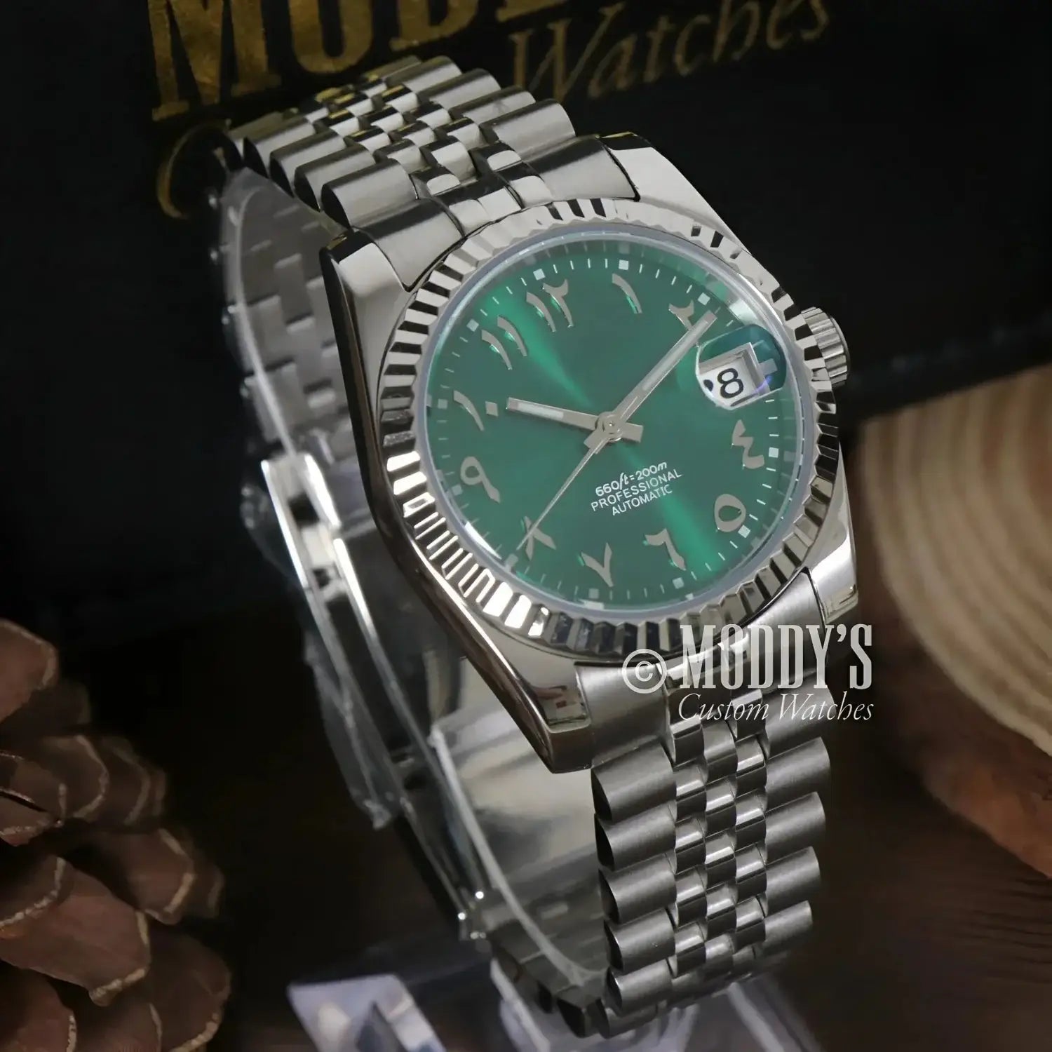 Silver wristwatch with green face from Seikojust Royal Green Arabic, featuring NH35 automatic movement