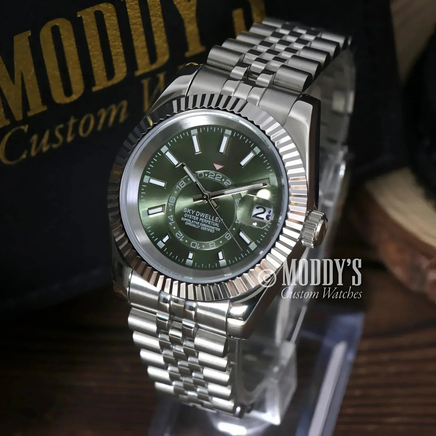 Silver wristwatch with green face, showcasing Seiko NH35 automatic, Sky Dweller Mint