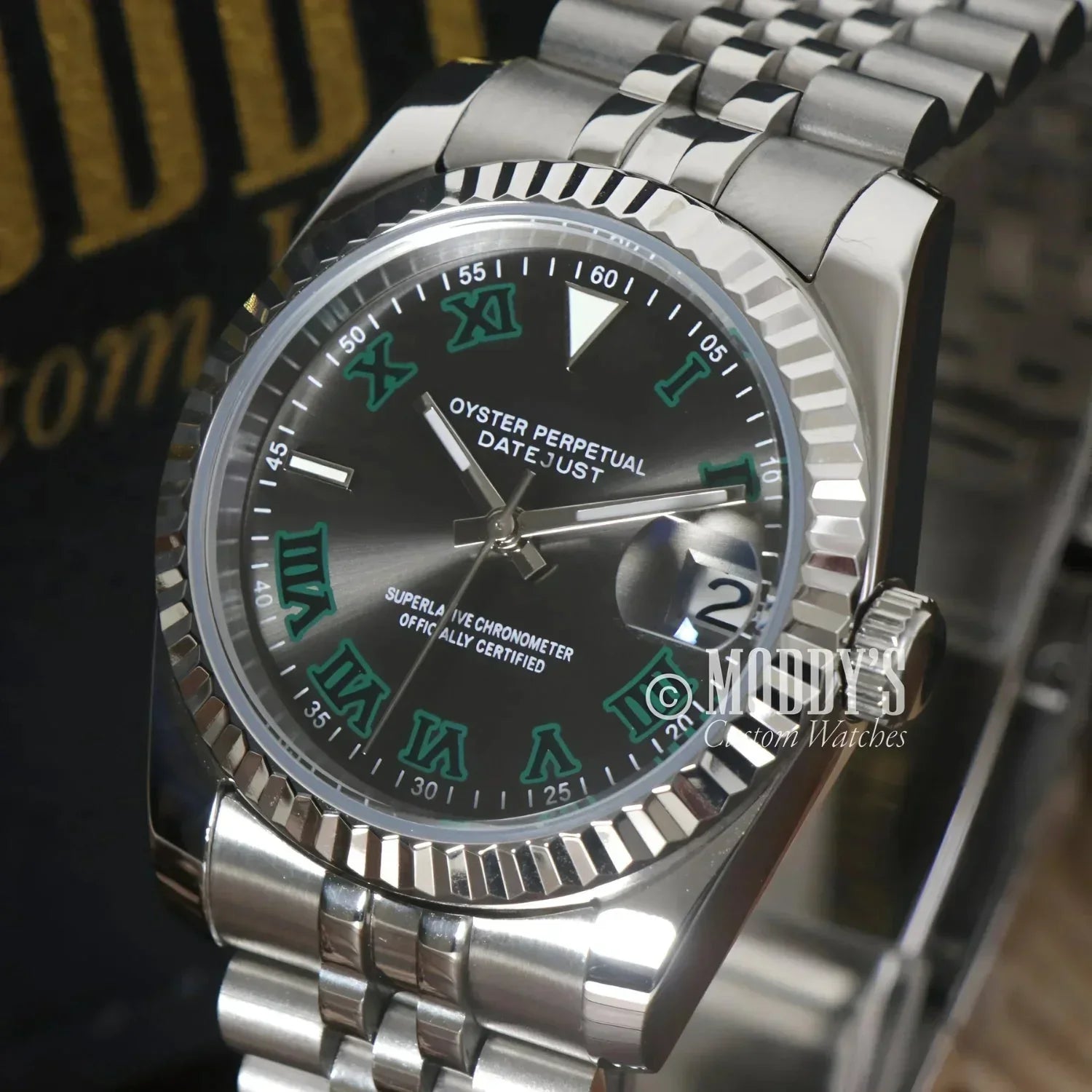 Silver Rolex Datejust watch with green Roman numerals in Seiko Mod style