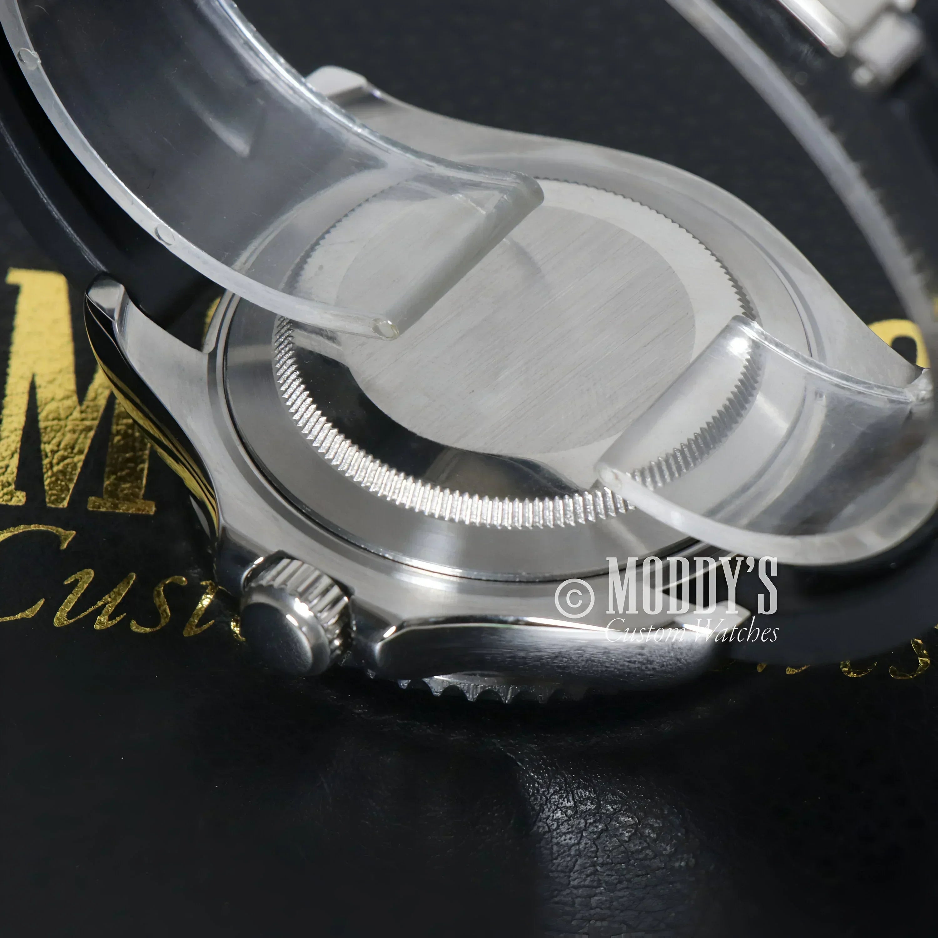 Silver wristwatch with protective plastic featuring Seiko NH35 automatic movement