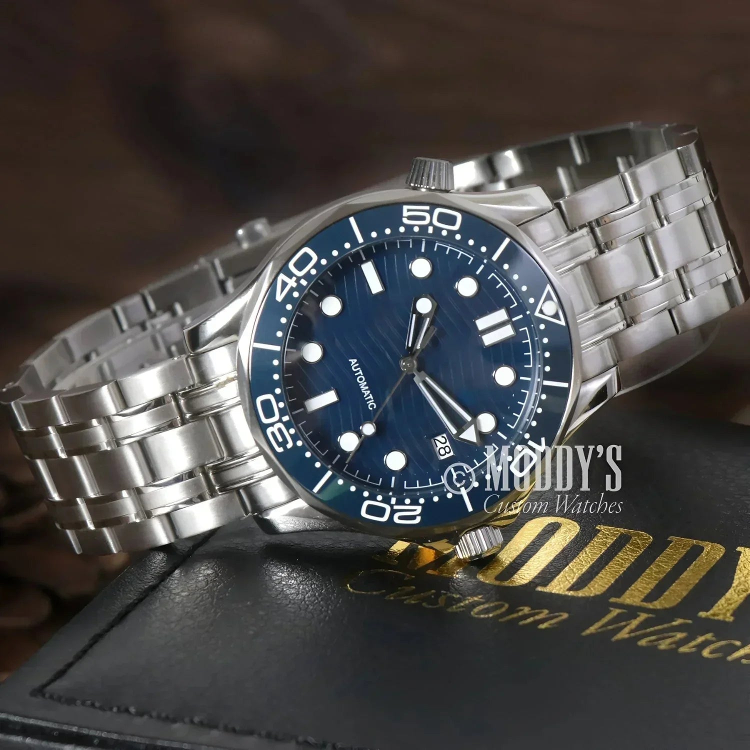 Silver wristwatch with blue face featuring NH35 automatic movement, Seiko mod Seamaster design