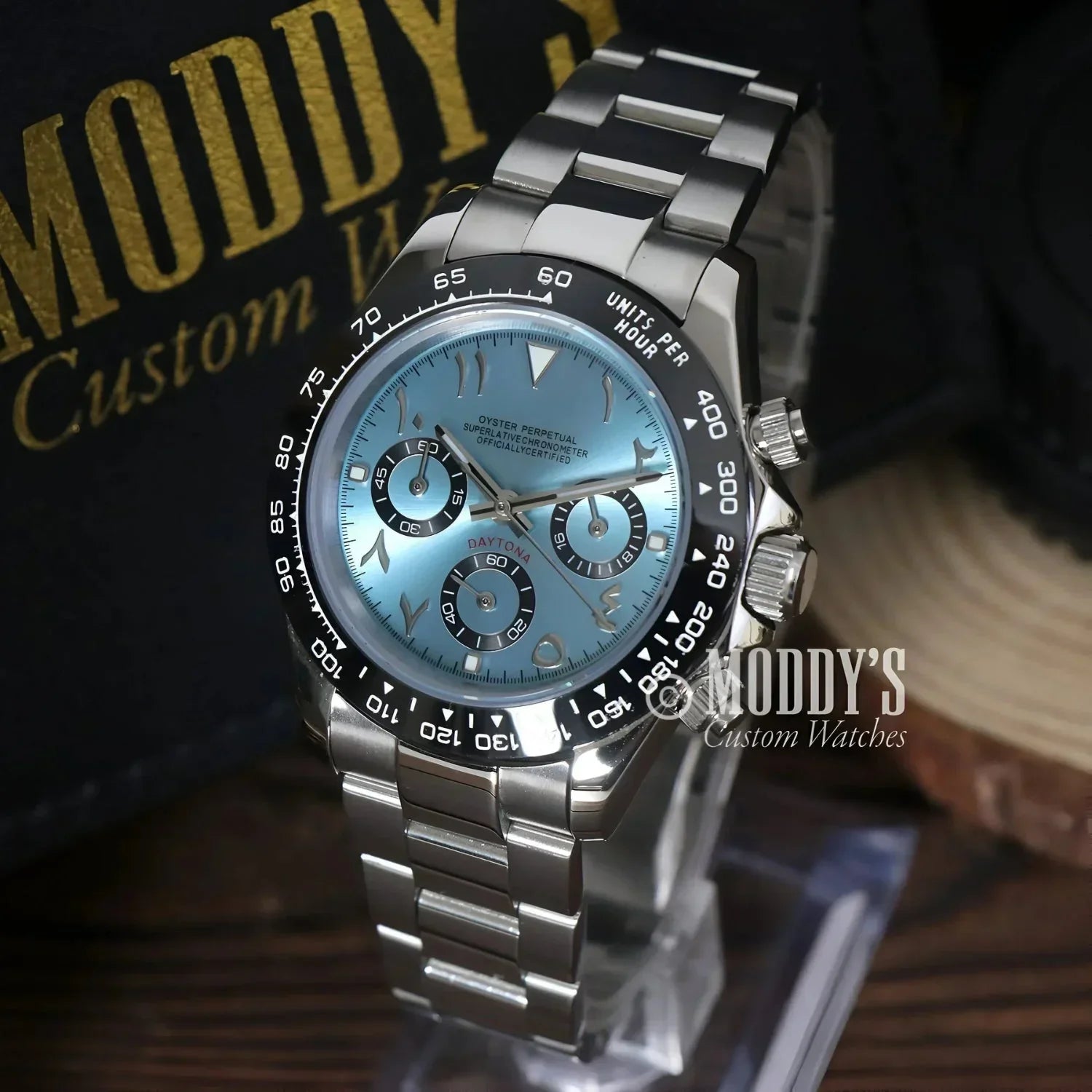 Silver wristwatch with a light blue face featuring Seiko VK63 hybrid movement