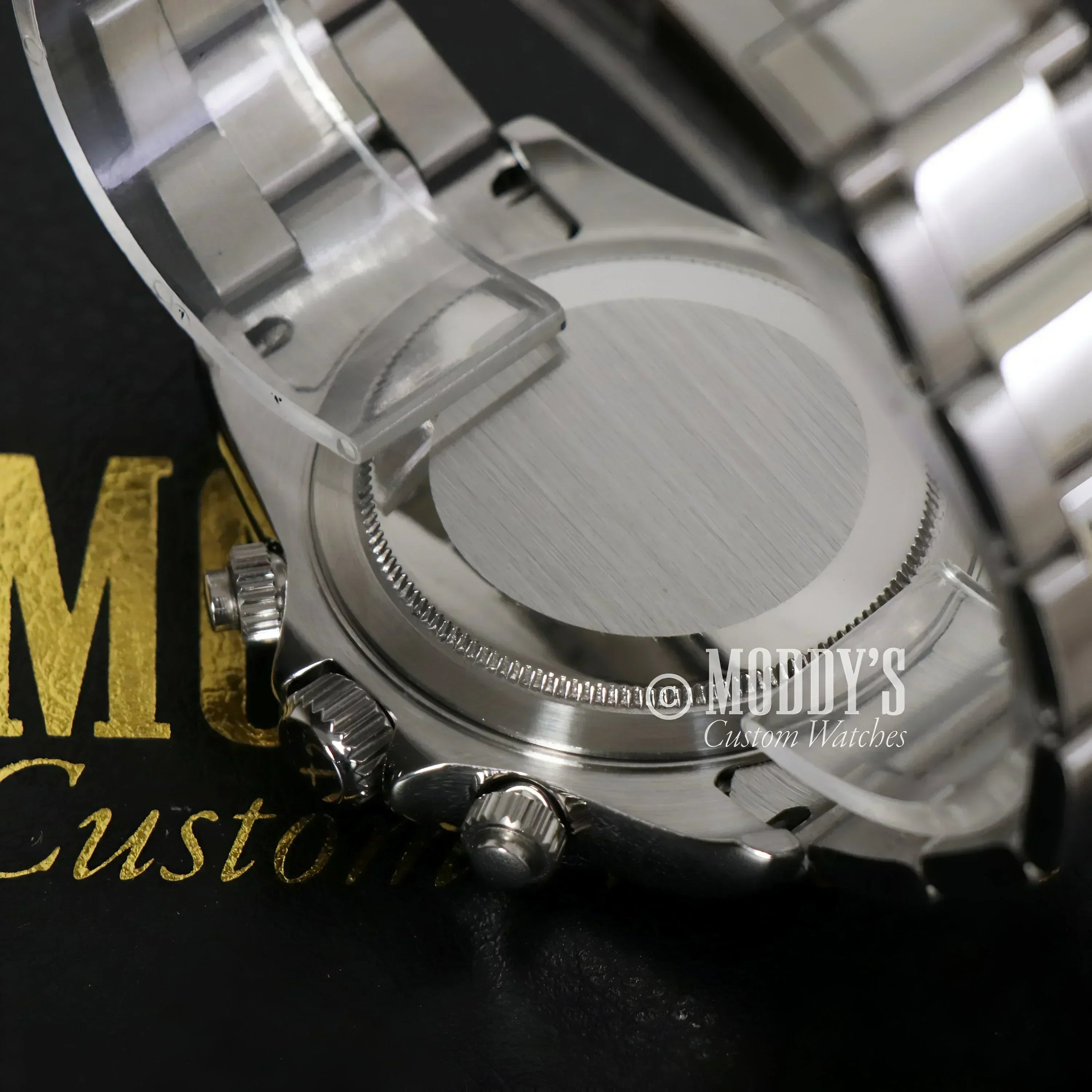 Silver wristwatch back of Seitona Black Panda featuring VK63 hybrid movement