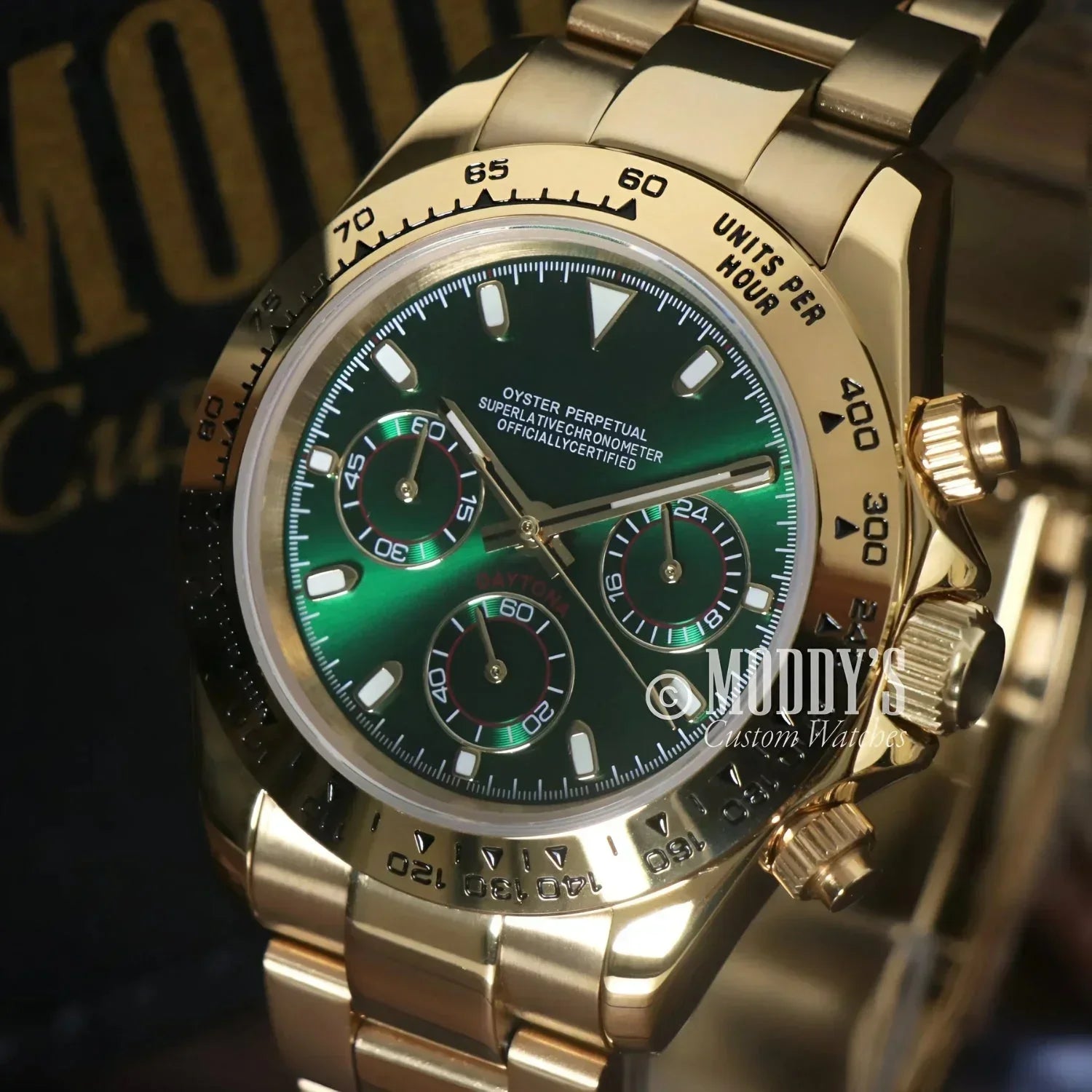 Gold Rolex Daytona watch with green face featuring Seiko VK63 hybrid movement
