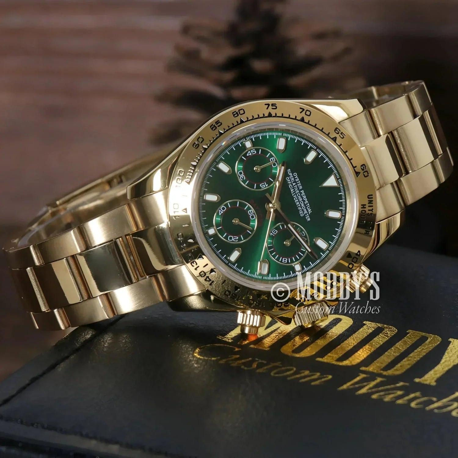 Gold Rolex Daytona watch with green face featuring Seiko VK63 hybrid movement