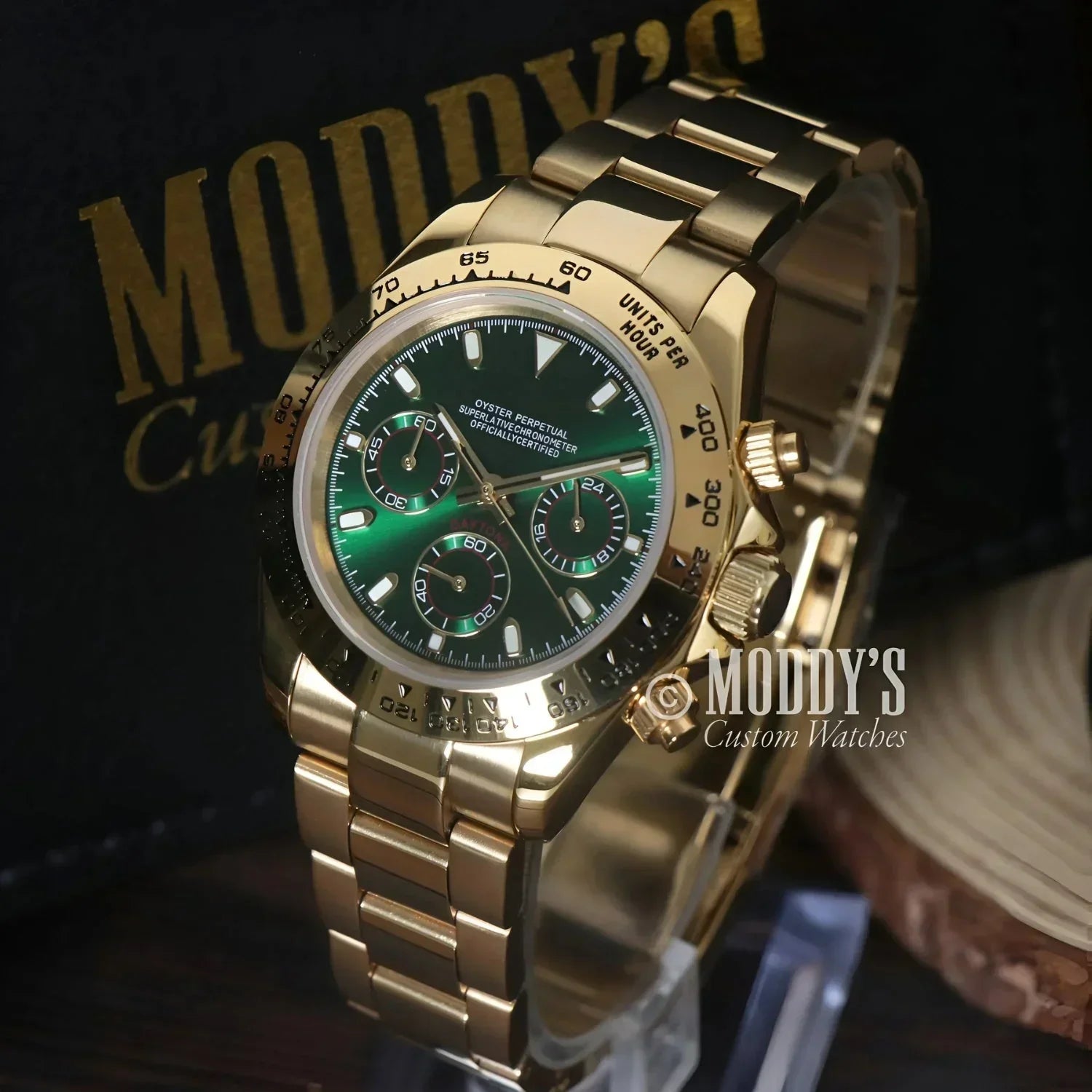 Gold Rolex Daytona watch with green face featuring Seiko VK63 hybrid movement