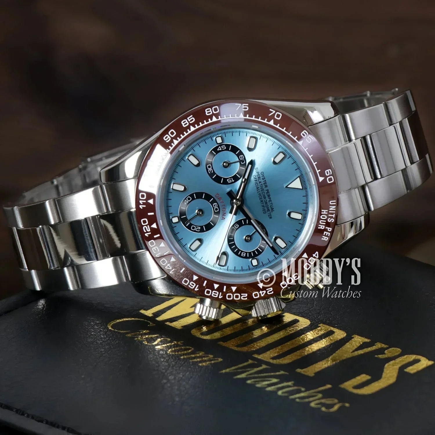 Silver wristwatch with light blue face featuring Seiko VK63 hybrid movement