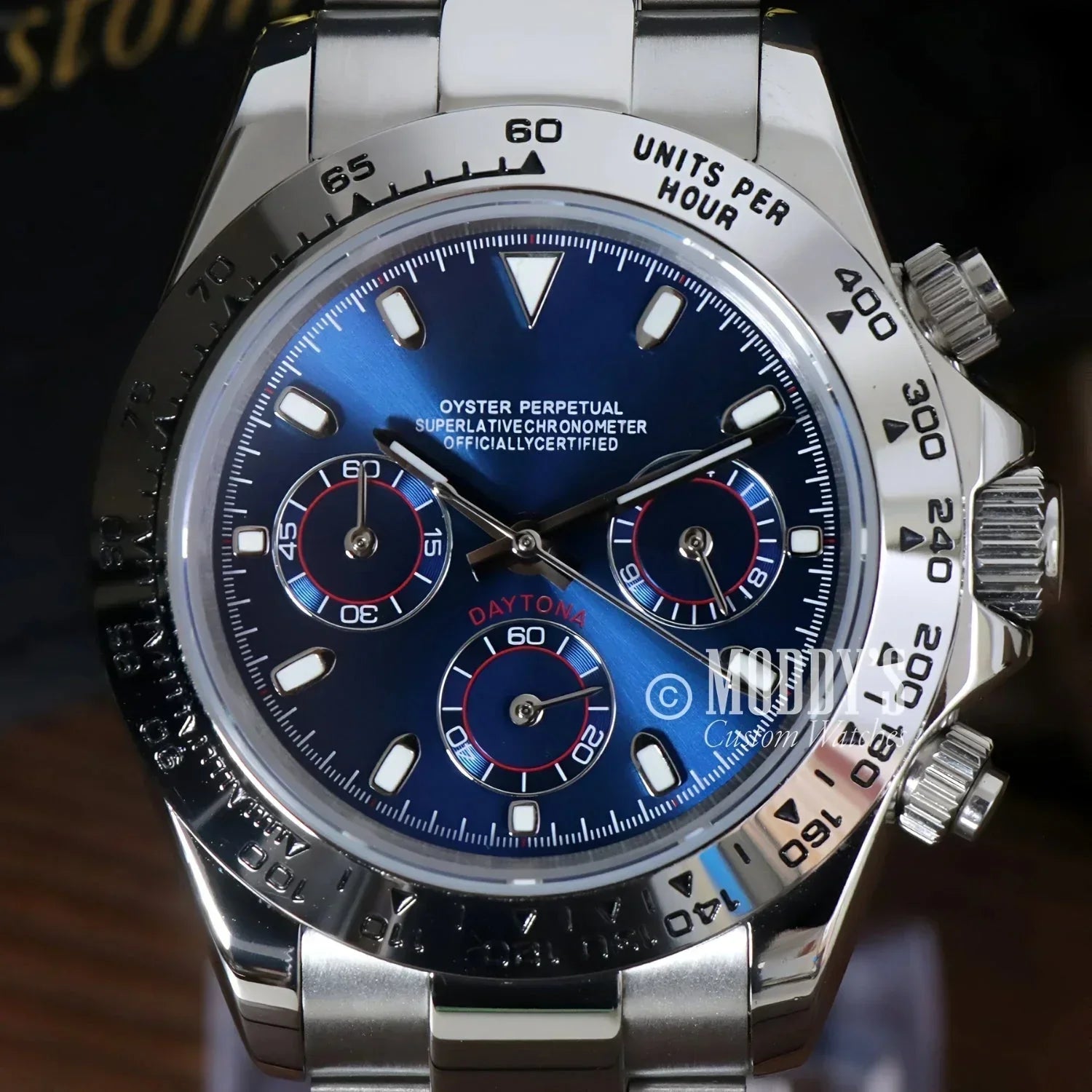 Silver Rolex Daytona watch with blue face featuring Seiko VK63 hybrid movement