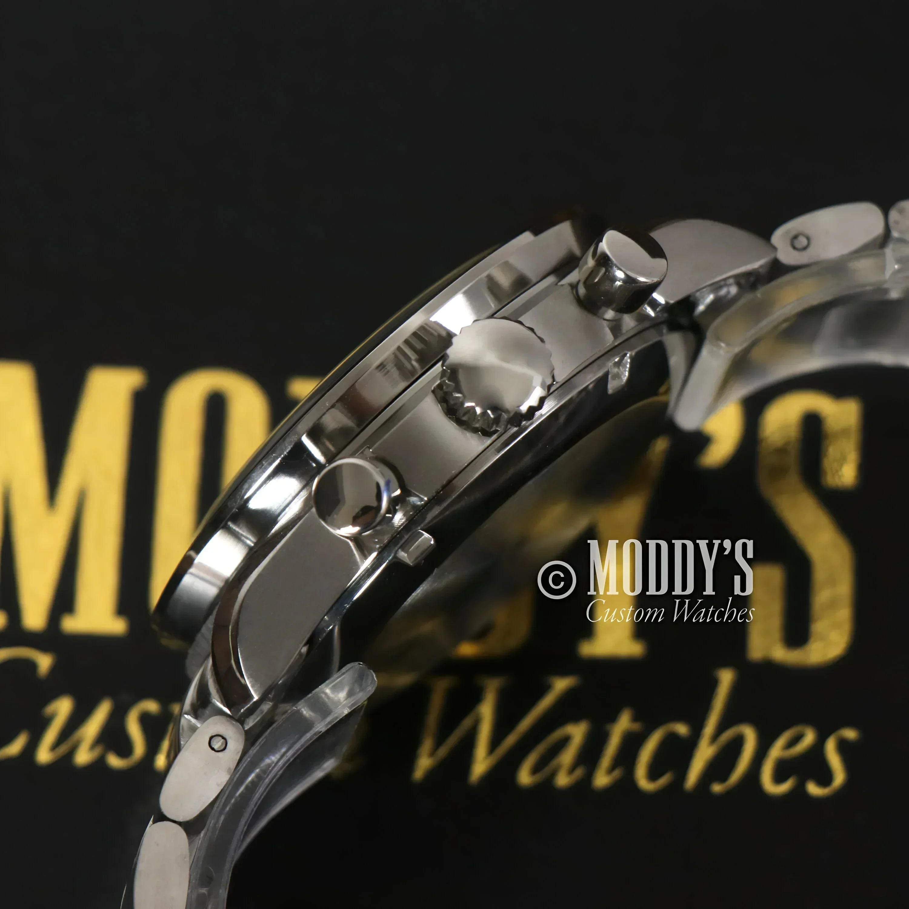 Silver wristwatch with buttons, featuring Seiko VK63 hybrid movement in Speedseiko Black