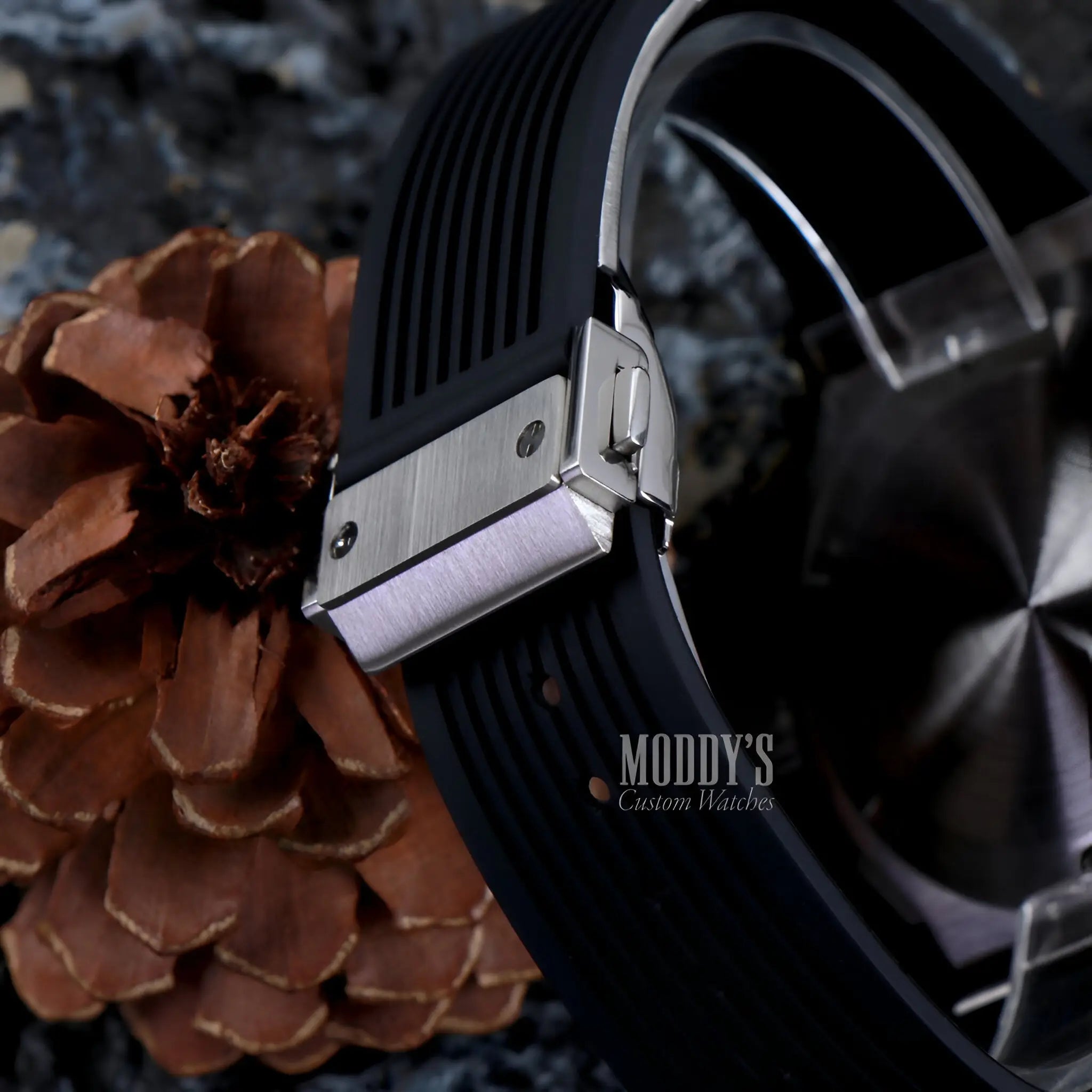 Hubleiko Big Bang Black watch with VK63 hybrid movement on pinecone background