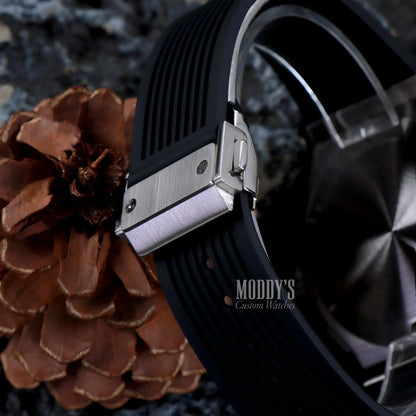 Hubleiko Big Bang Black watch with VK63 hybrid movement on pinecone background