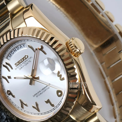 Gold Seiko mod watch with white face, Roman numerals, automatic movement