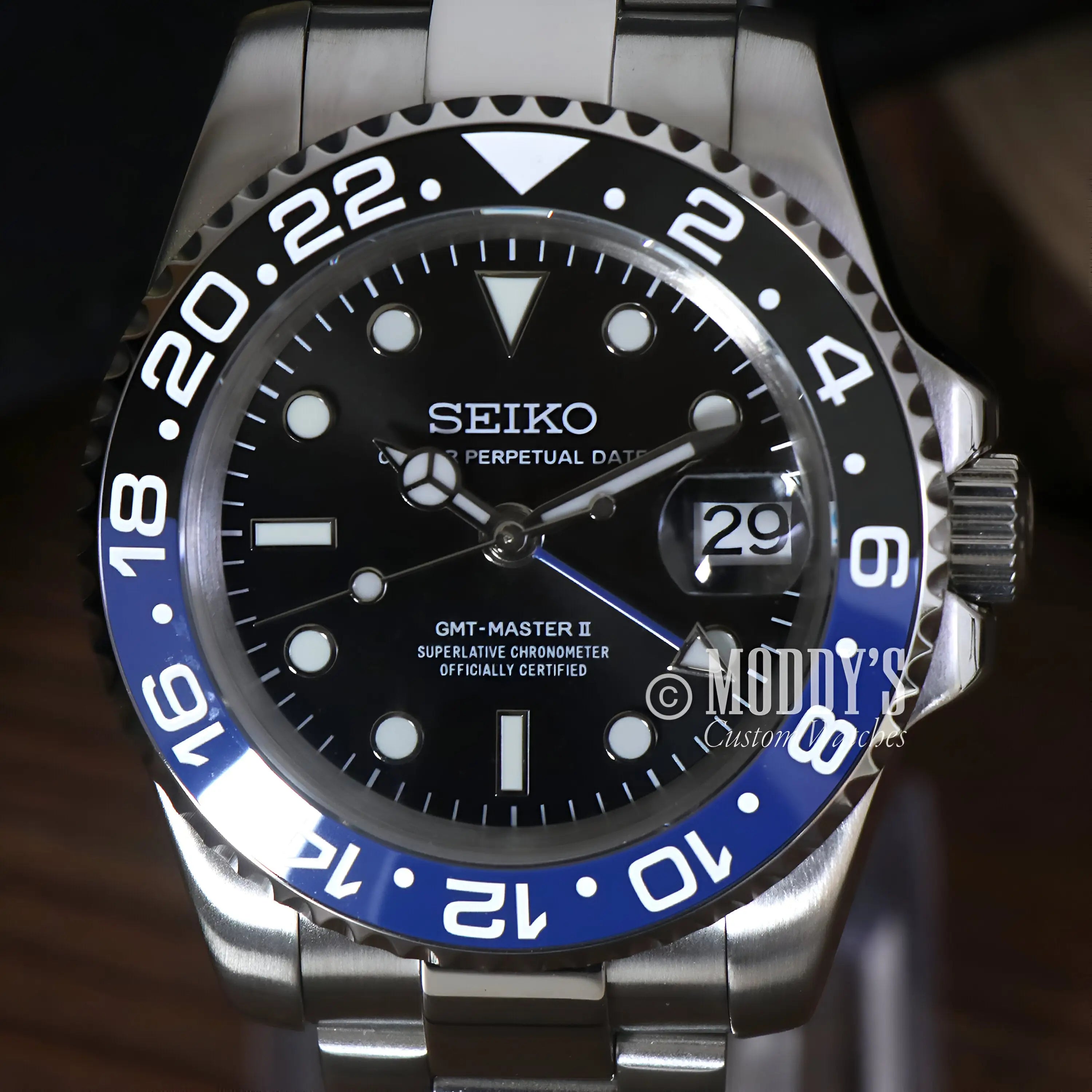 Seiko mod GMT NH34 automatic movement watch with black dial and Batman bezel