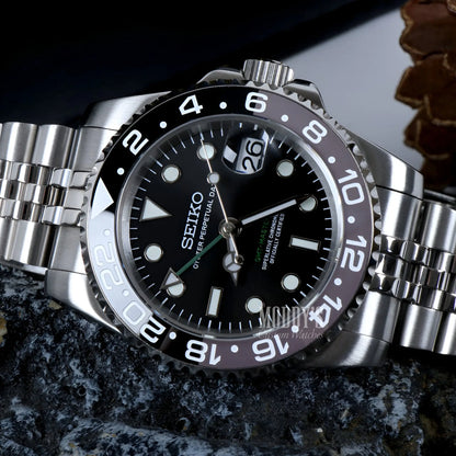 Seiko NH34 automatic GMT mod watch with black dial and silver bezel