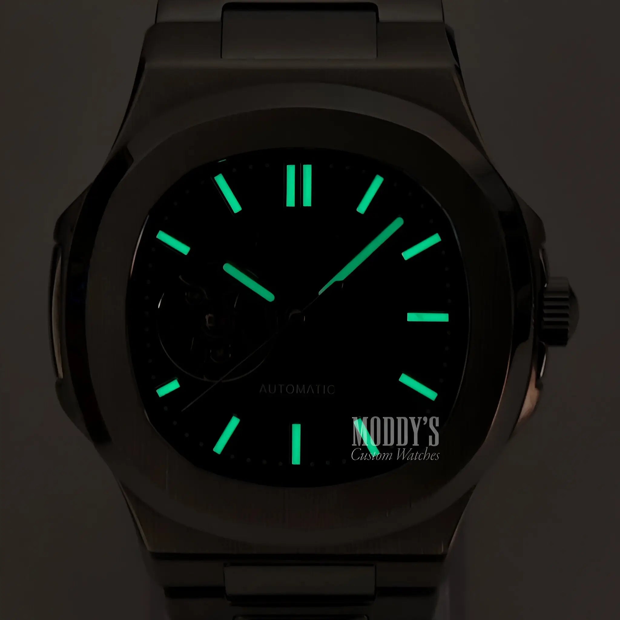 Green glow-in-the-dark Seiko mod Nautilus watch with black open movement
