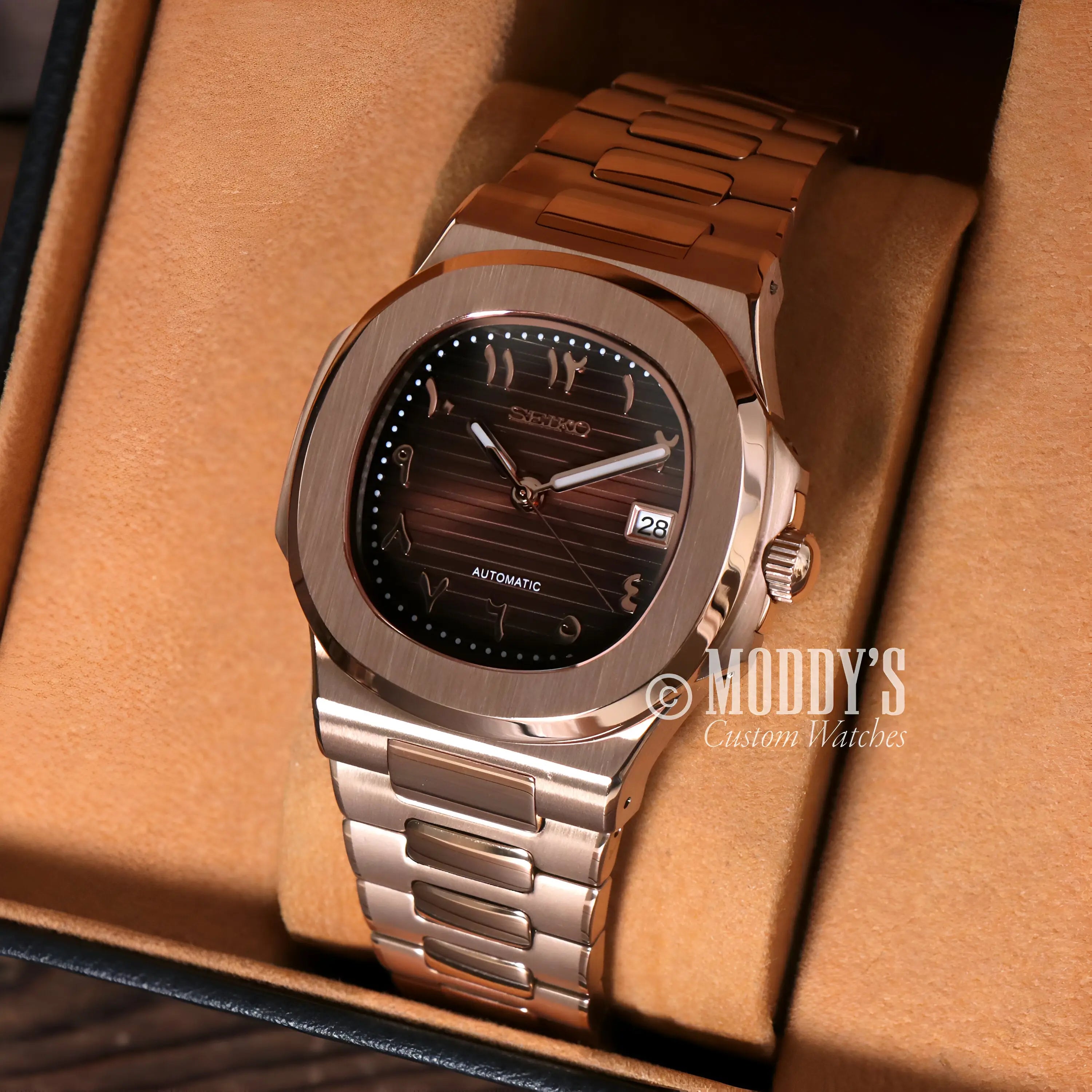 Rose gold Patek Philippe Nautilus watch with brown dial and date window
