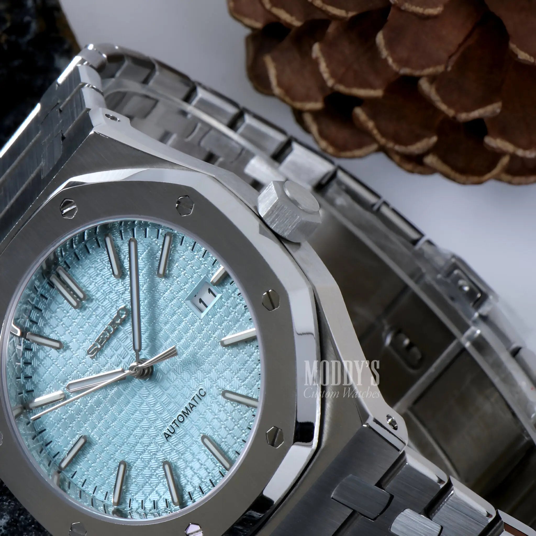Silver Audemars Piguet Royal Oak mod watch with ice blue dial