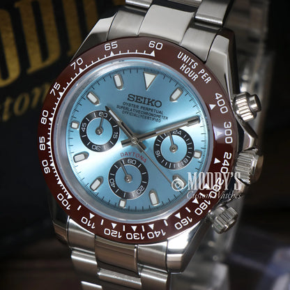 Seiko VK63 hybrid chronograph with blue dial, red bezel, stainless steel case