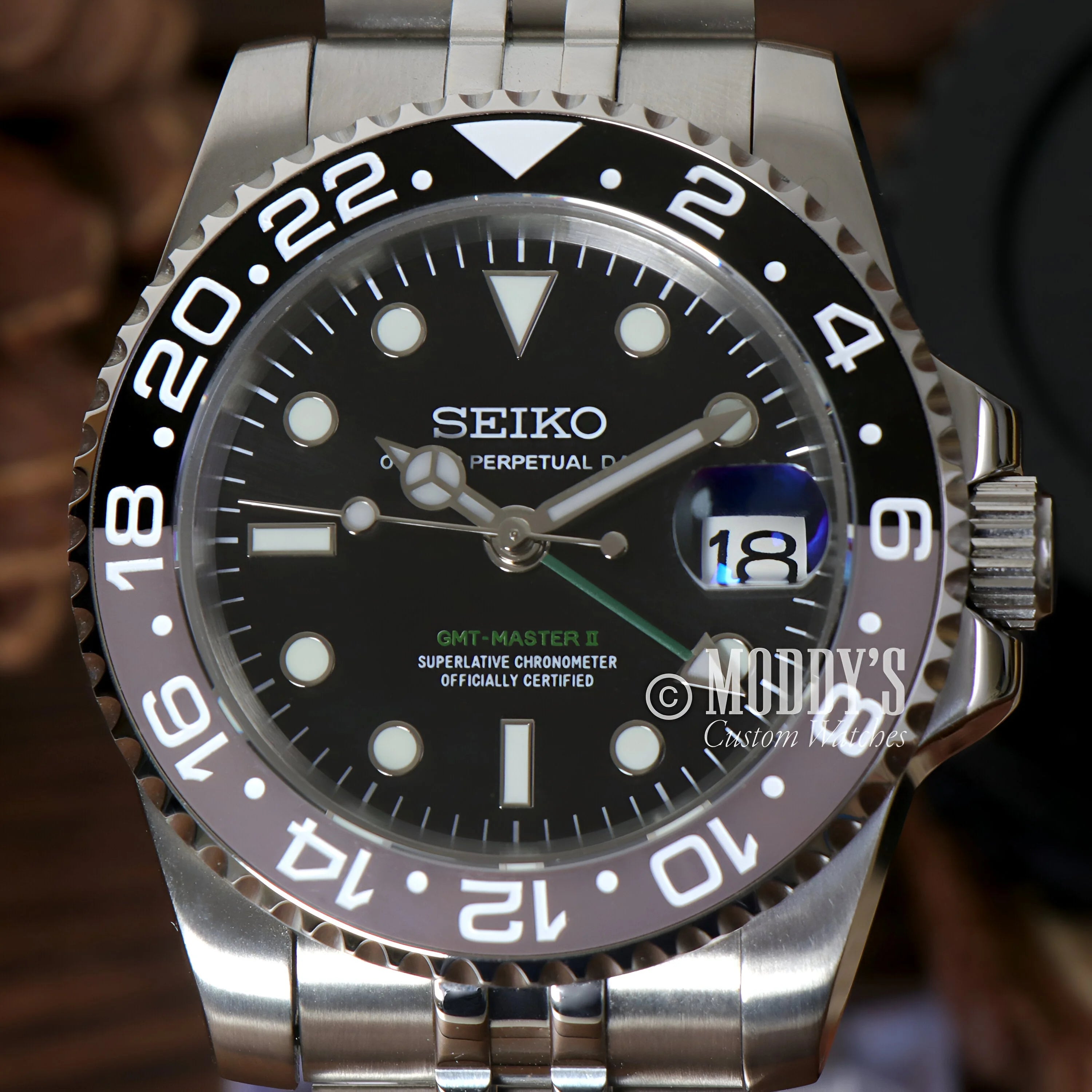 Seiko GMT dive watch with black dial, rotating bezel, and durable 904L stainless steel