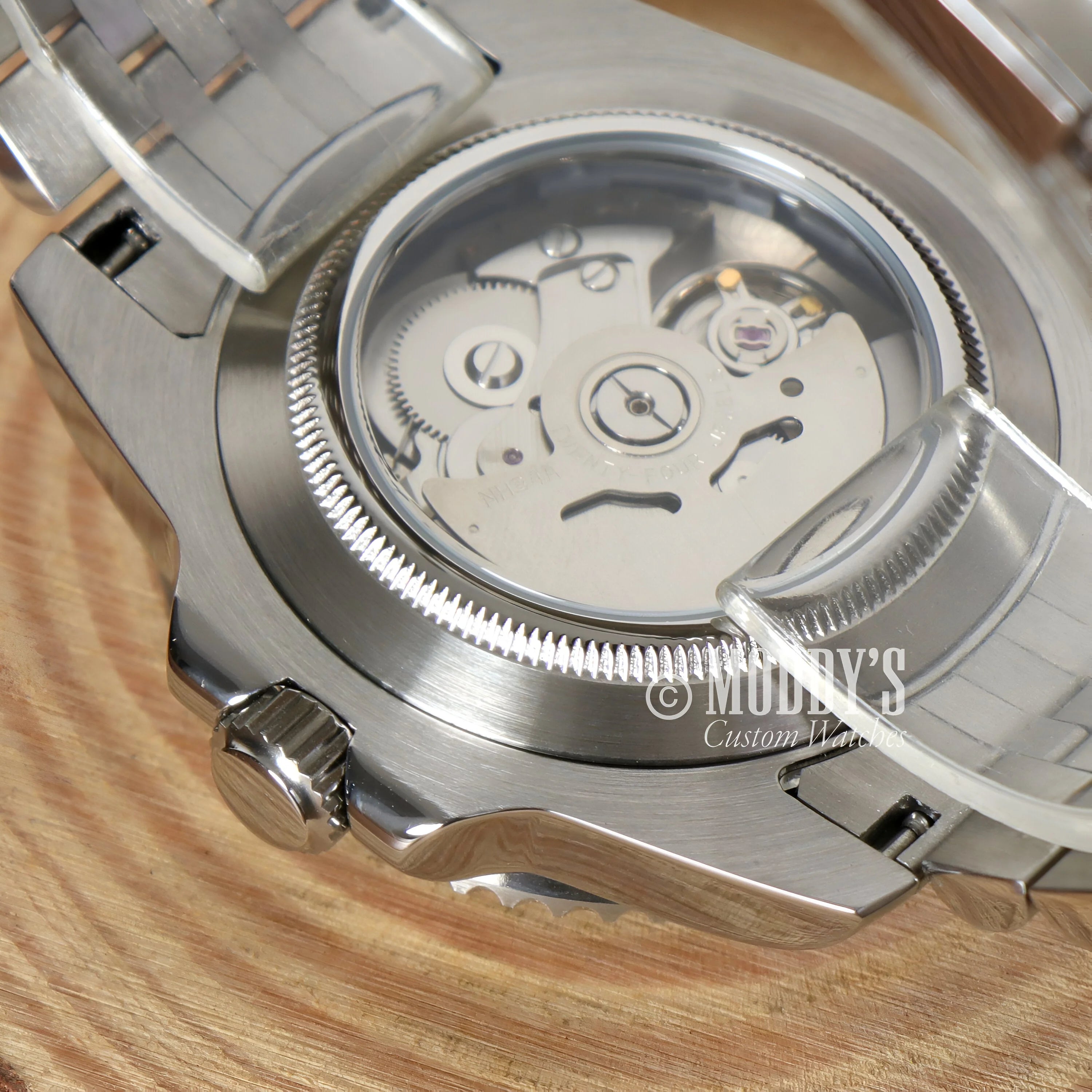 Mechanical watch movement of GMTeiko Bruce Wayne in transparent case back, featuring Seiko NH34