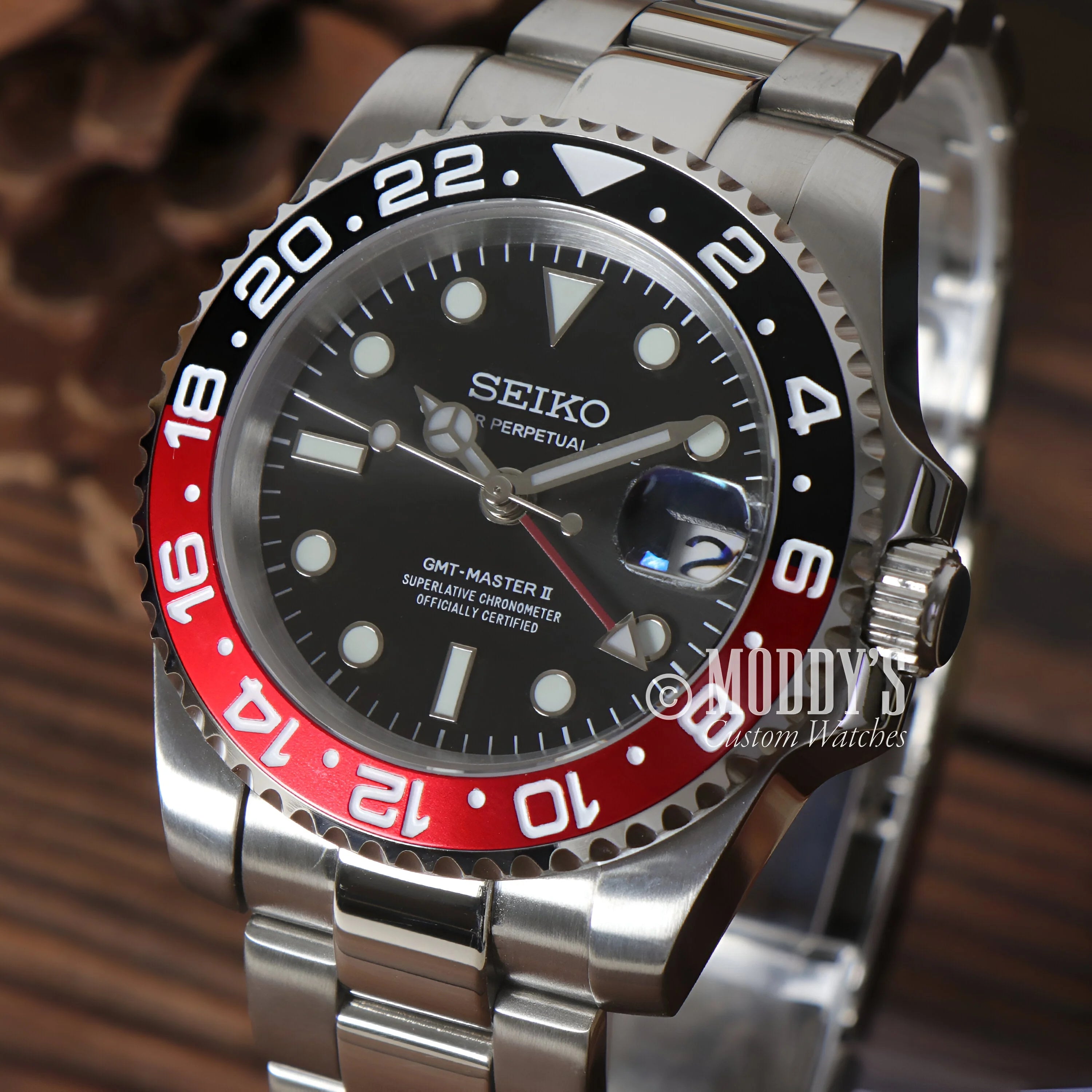 Seiko GMT dive watch featuring a black dial and Pepsi bezel in GMTeiko Coke model