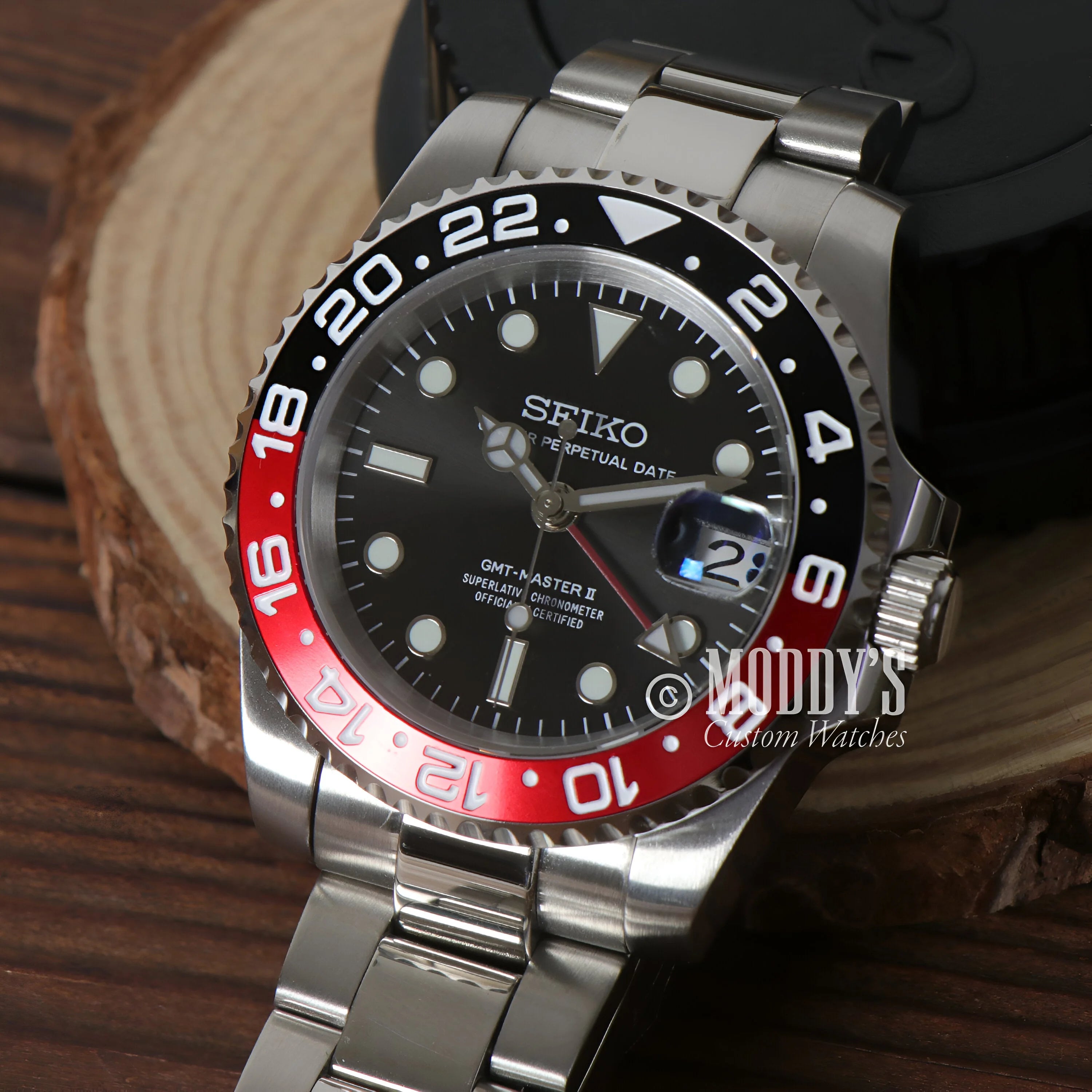 Seiko GMT dive watch with black dial and red black Coke bezel in GMTeiko case