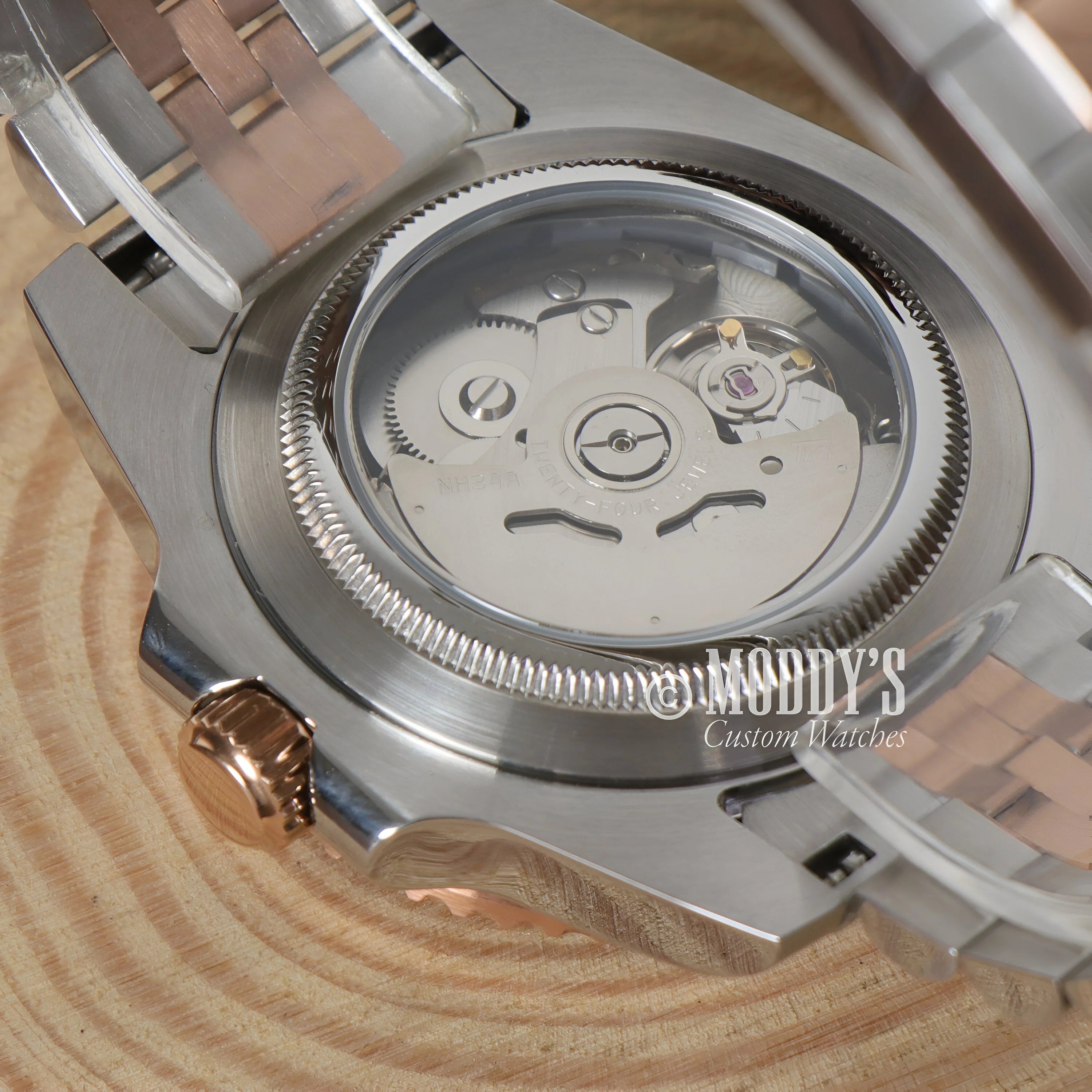 Clear watch caseback of GMTeiko Rootbeer showcasing Seiko mod GMT automatic movement