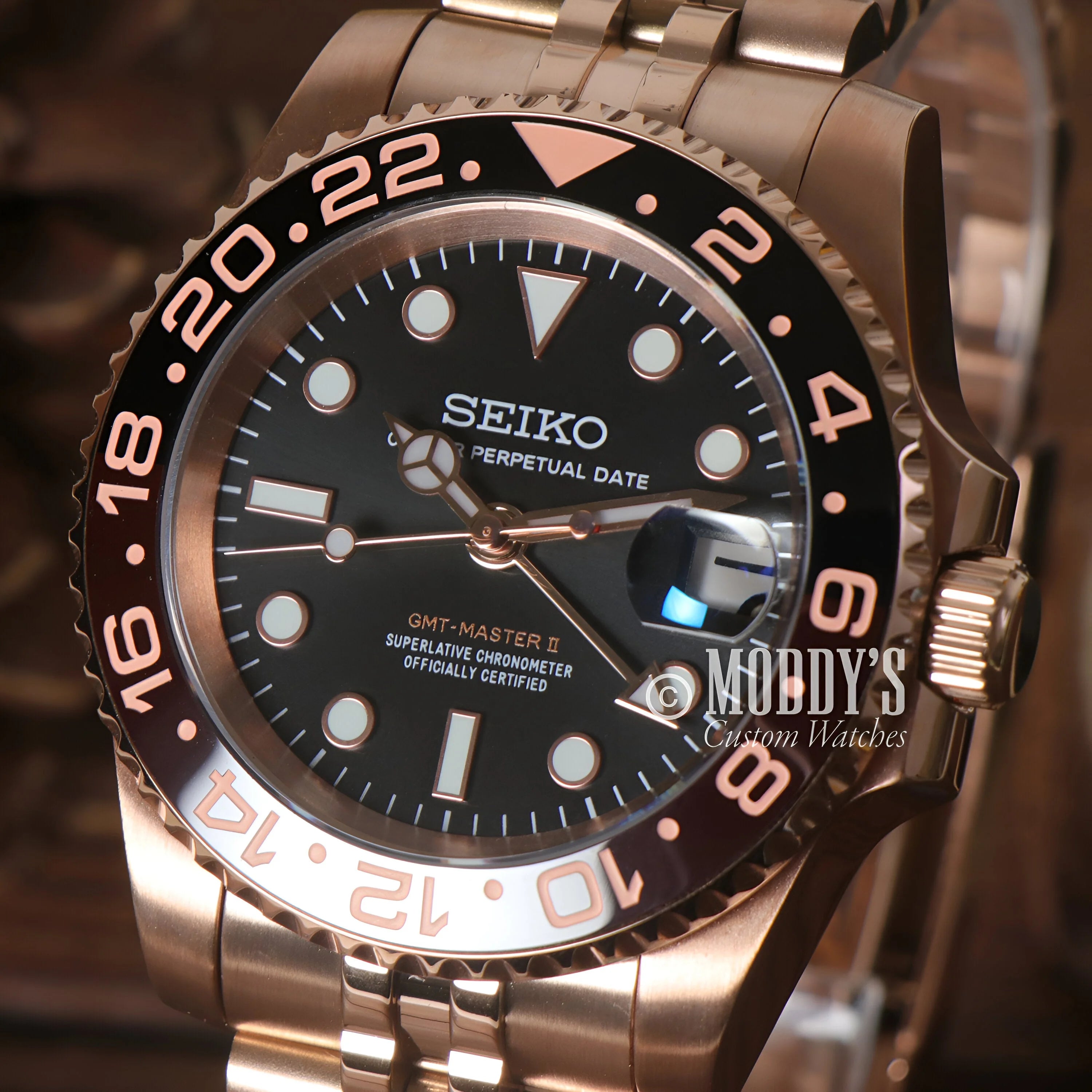 Seiko dive watch with black dial and rose gold-toned case, GMTeiko Rootbeer model