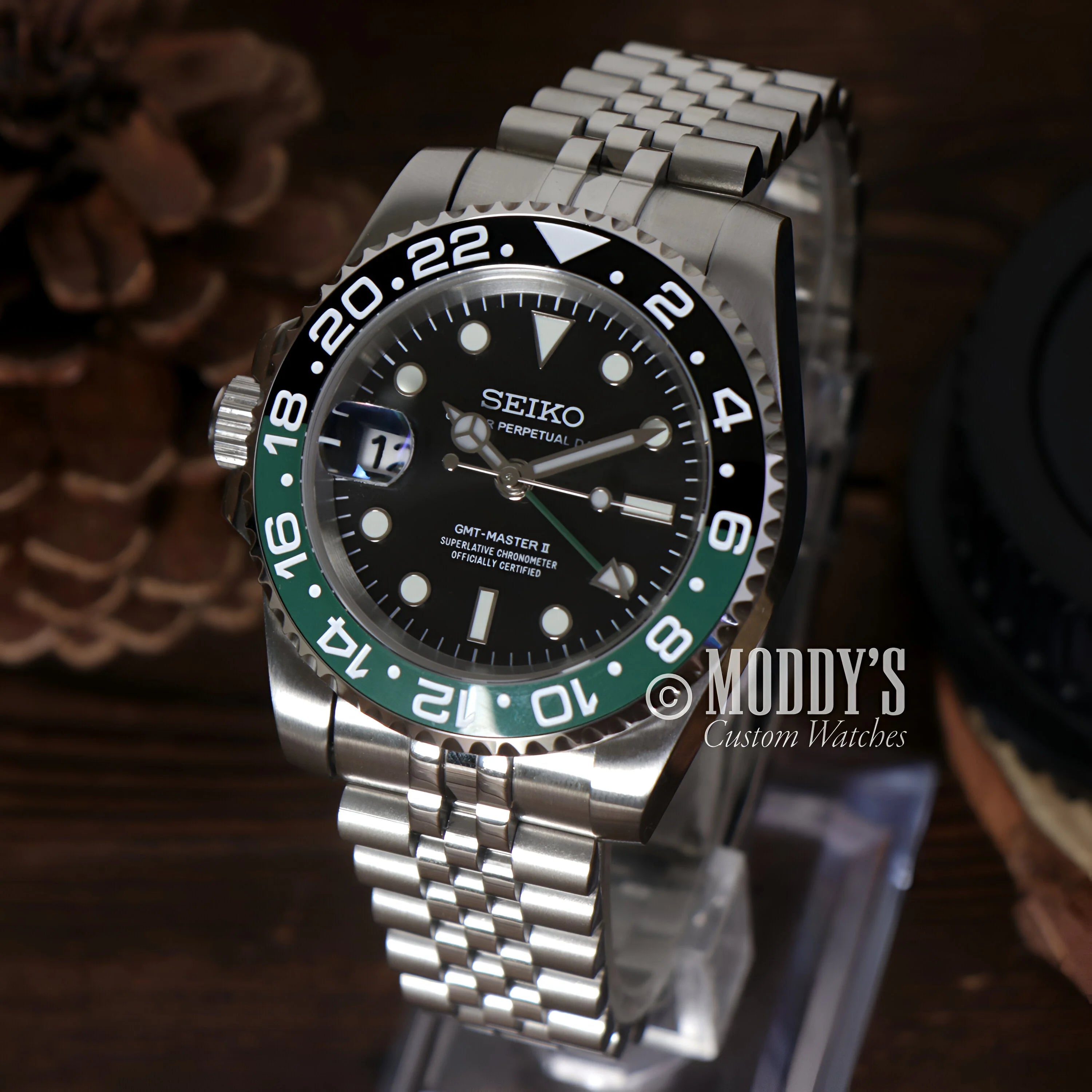 Seiko mod GMT with black dial, green/black bezel on stainless steel jubilee bracelet