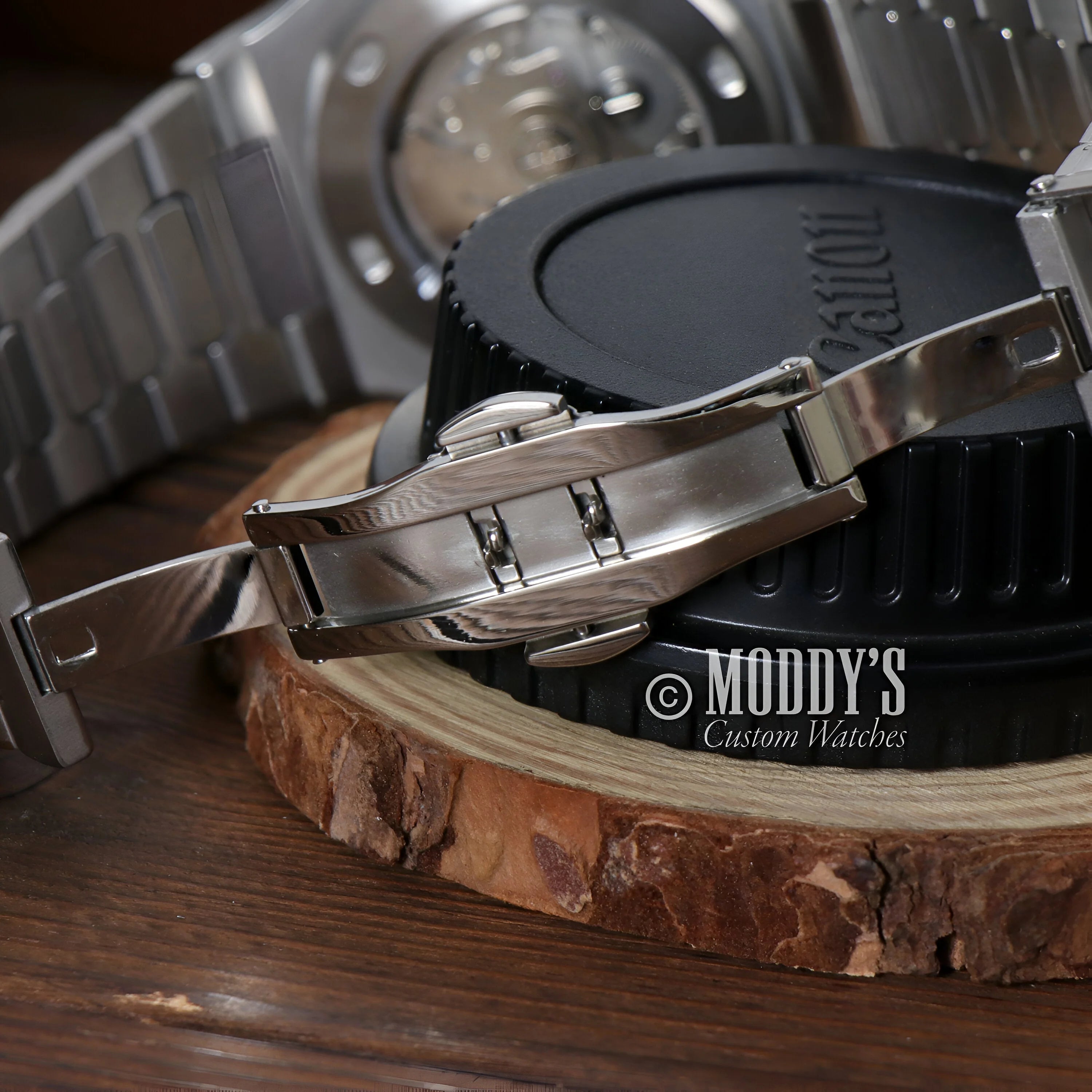 Metal watch bracelet with deployant clasp on wood surface for Seiko Mod Santos