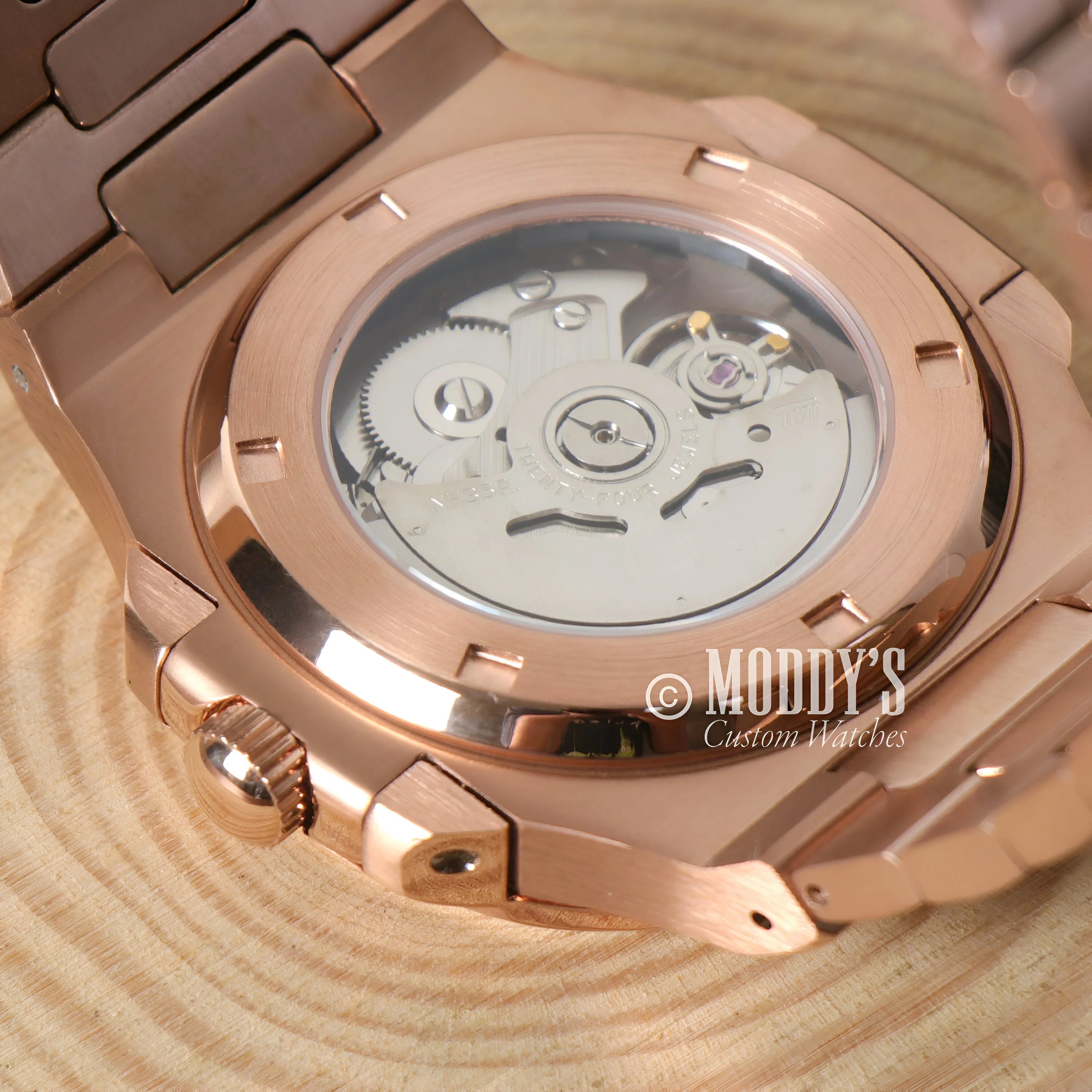 Rose gold watch movement showcased in Nautiko Rose Gold Black with transparent case back