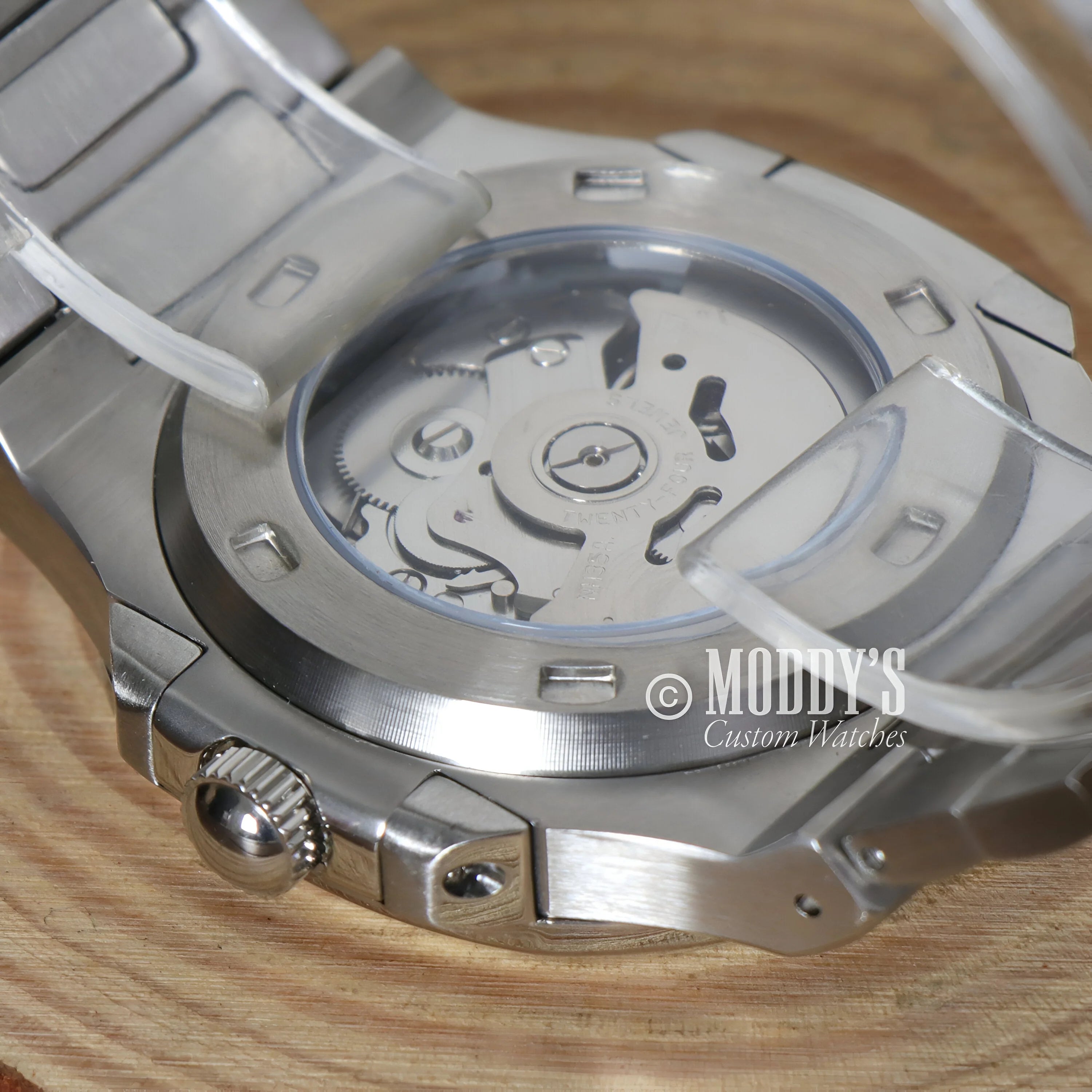 Stainless steel watch case back revealing Nautiko White’s automatic movement mechanism